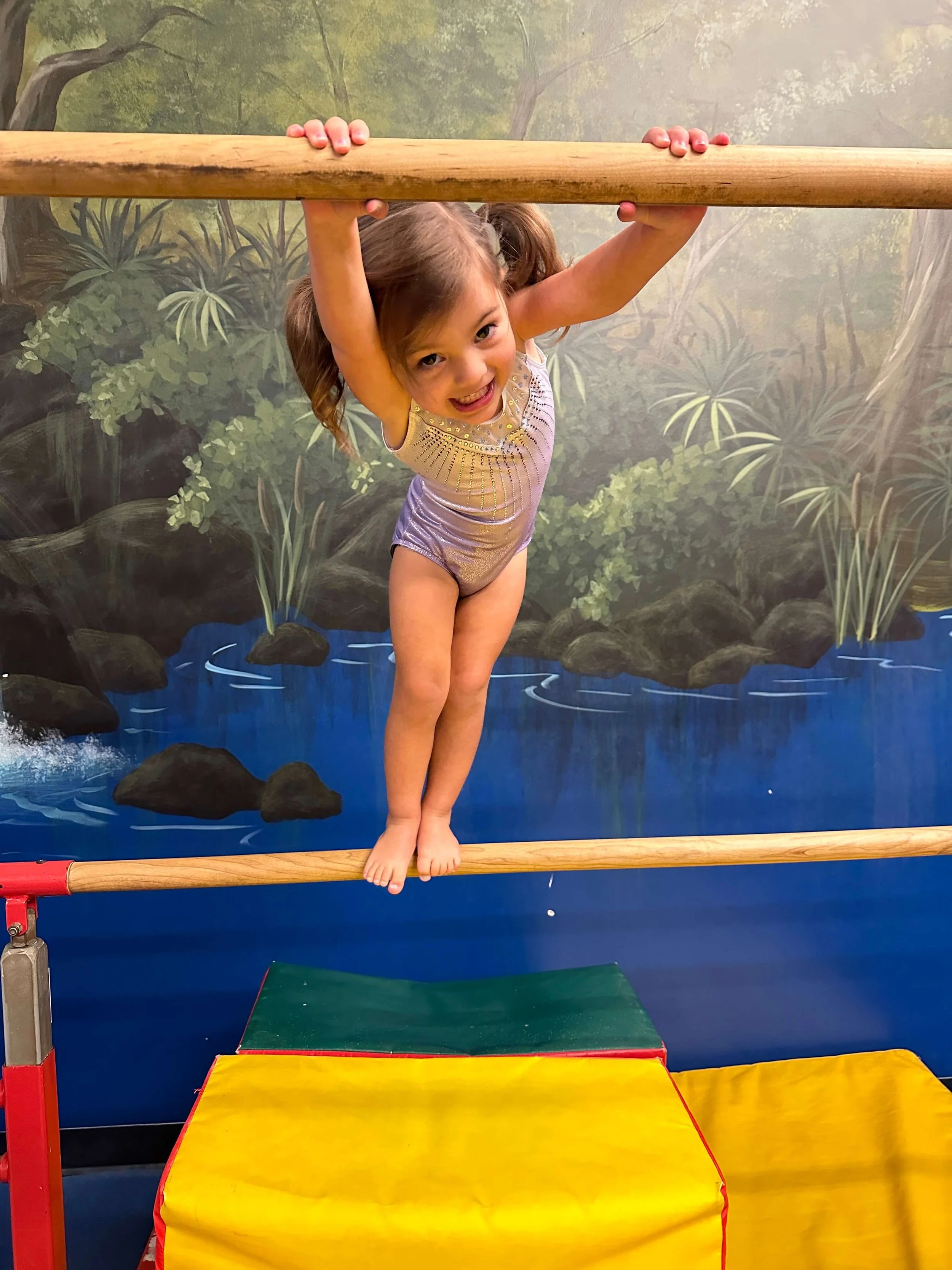 preschool girl in leotard in gym
