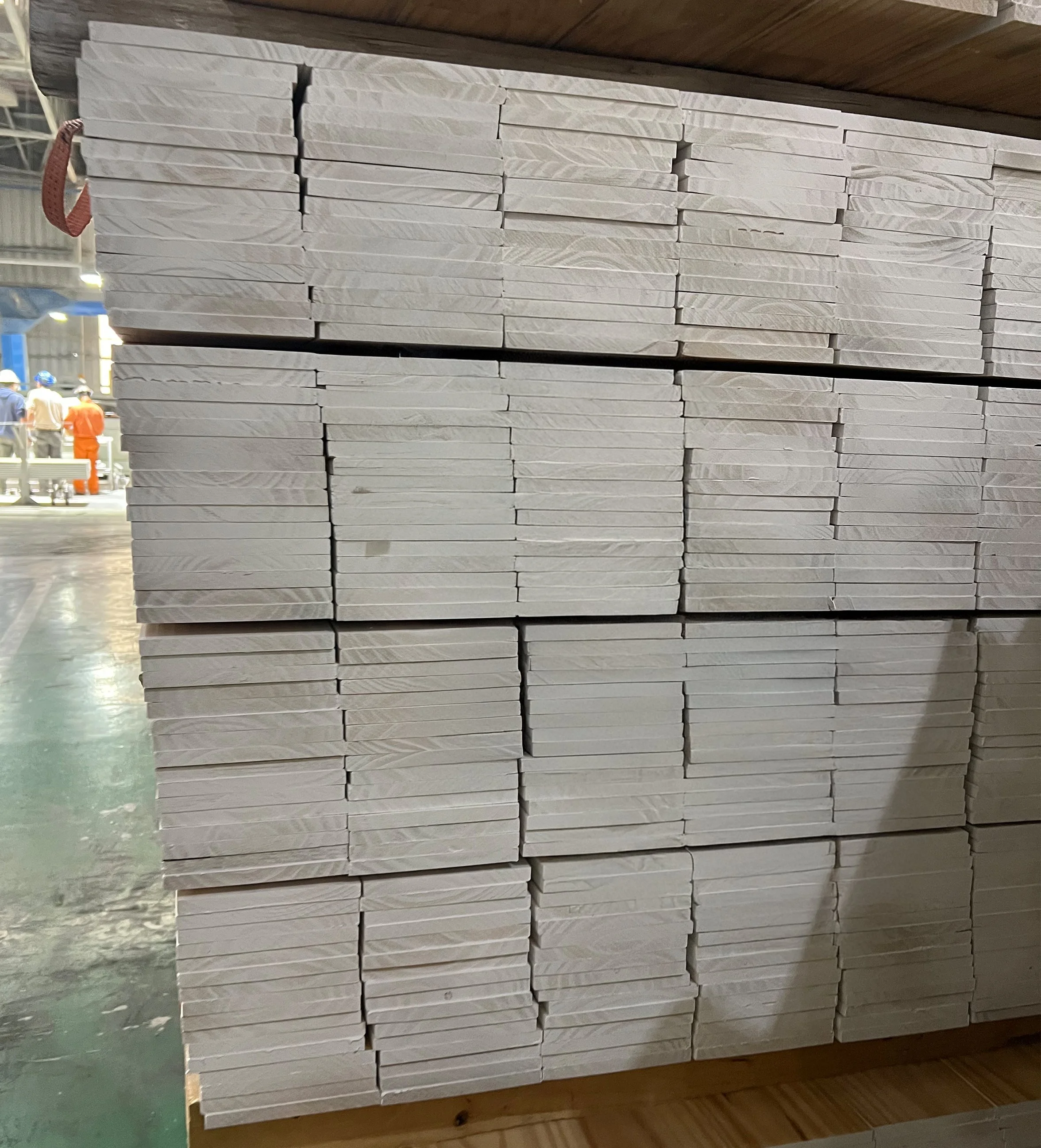 Pine moulding FJ primed DAR in a sawmill ready for exporting .