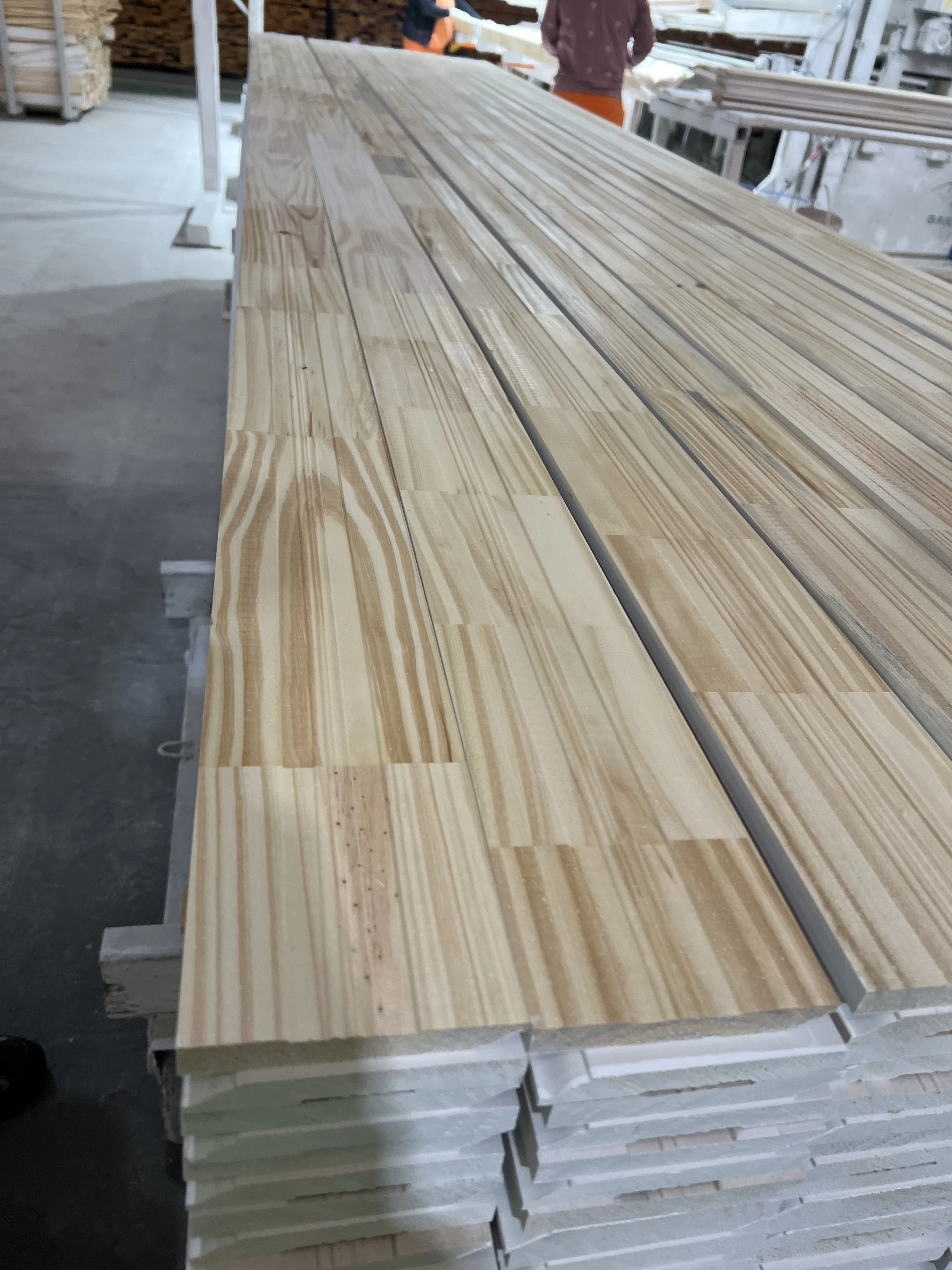 Pine moulding FJ primed one side  in a sawmill.