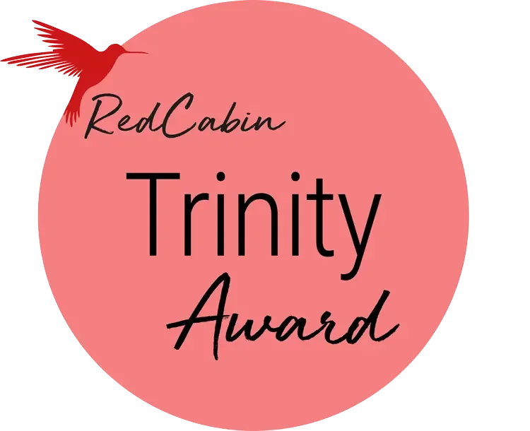 Pink circular award badge with a red bird logo, text 'RedCabin Trinity Award' in black.
