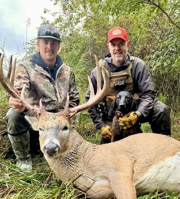 tracking dog and hunter with recovered white-tailed deer