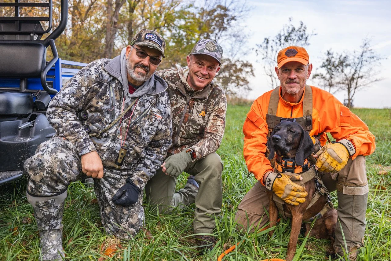 two hunters with handler and tracking dog after attempted recovery