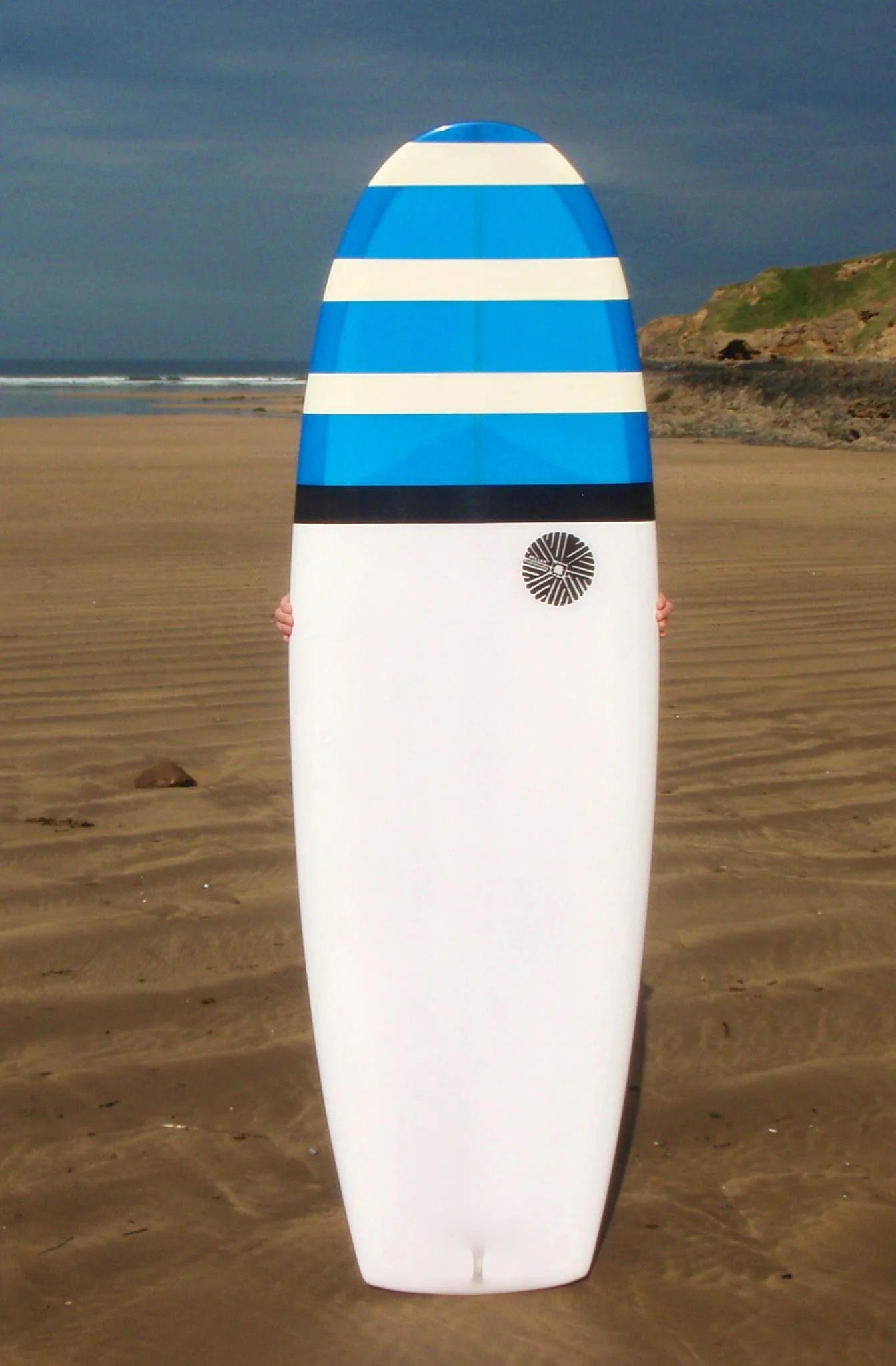 resin tint surfboard on suntan sands beach