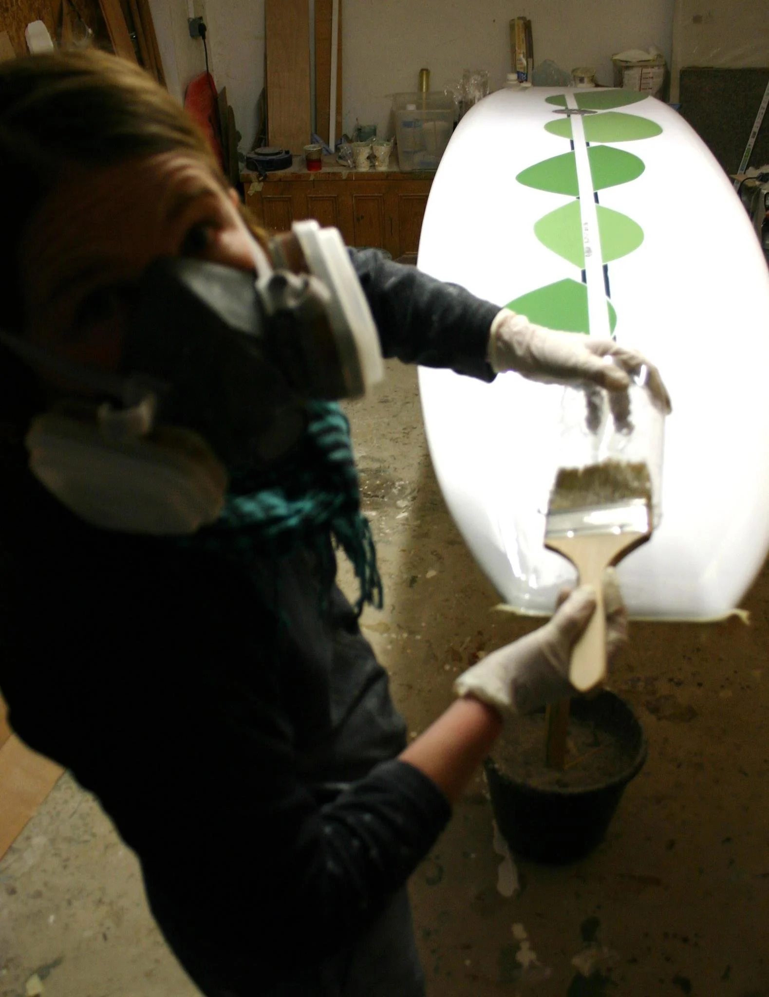 painting abstract resin panels on longboard