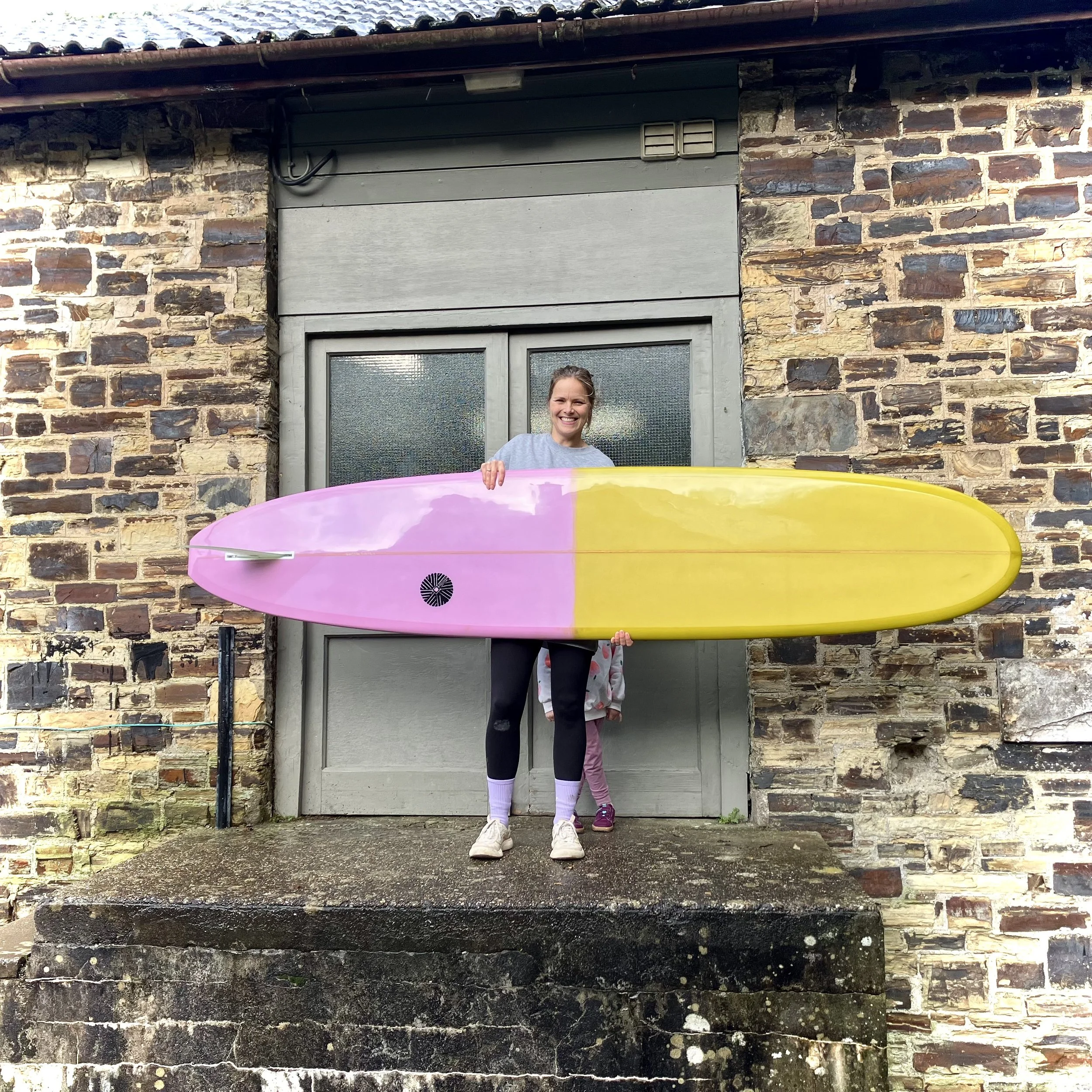 golden yellow and pink longboard surfboard