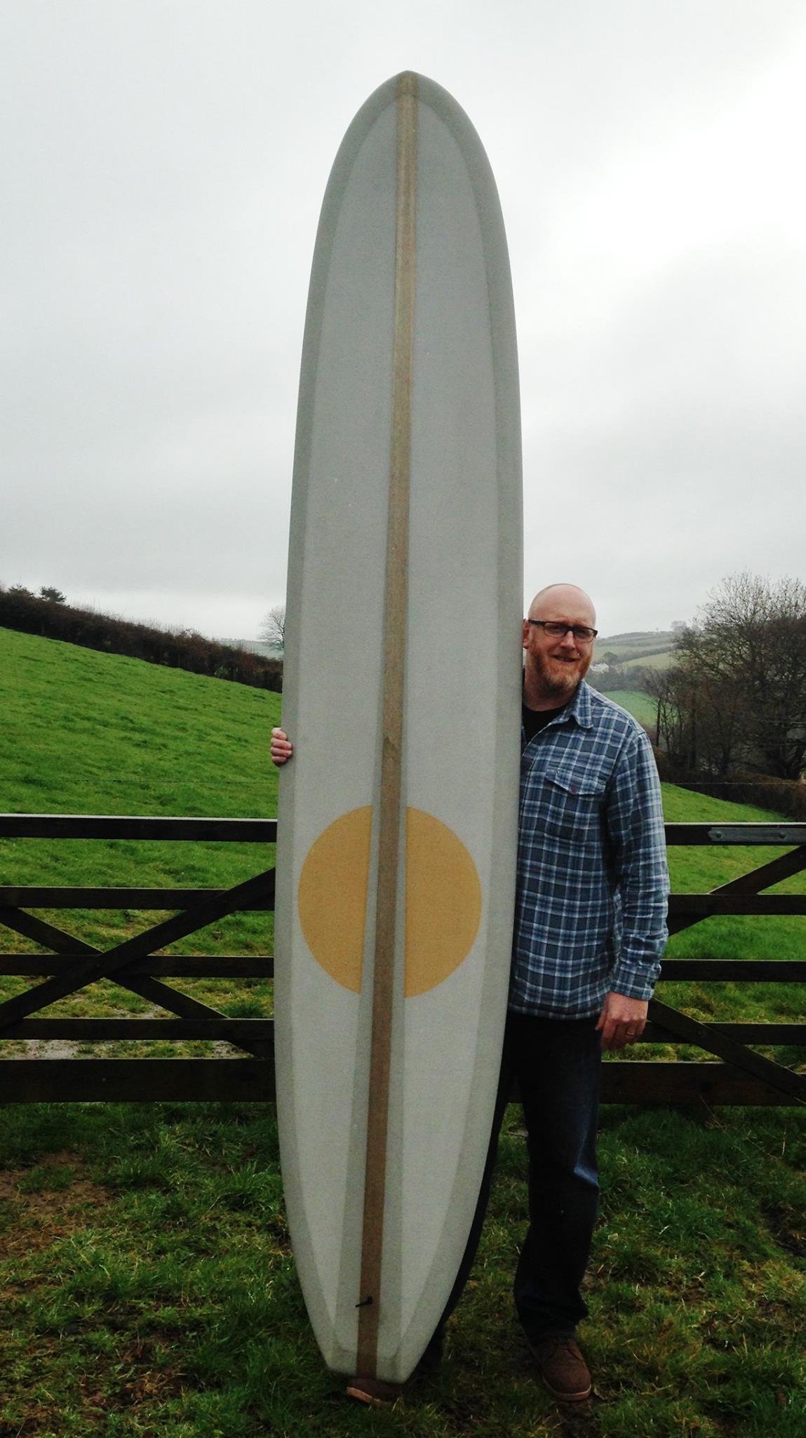 pig longboard surfboard with balsa stringer a nd resin circle panel