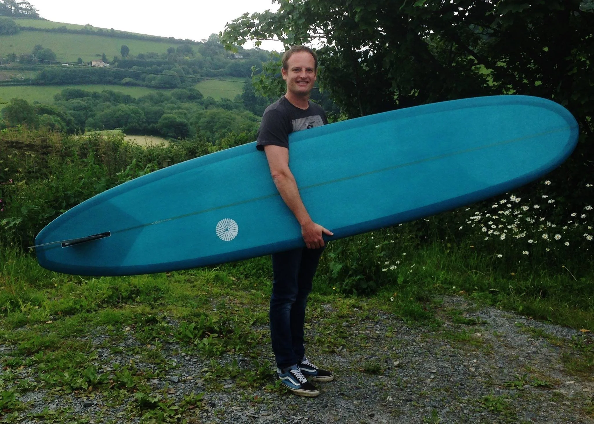 noserider longboard surfboard with blue resin tint