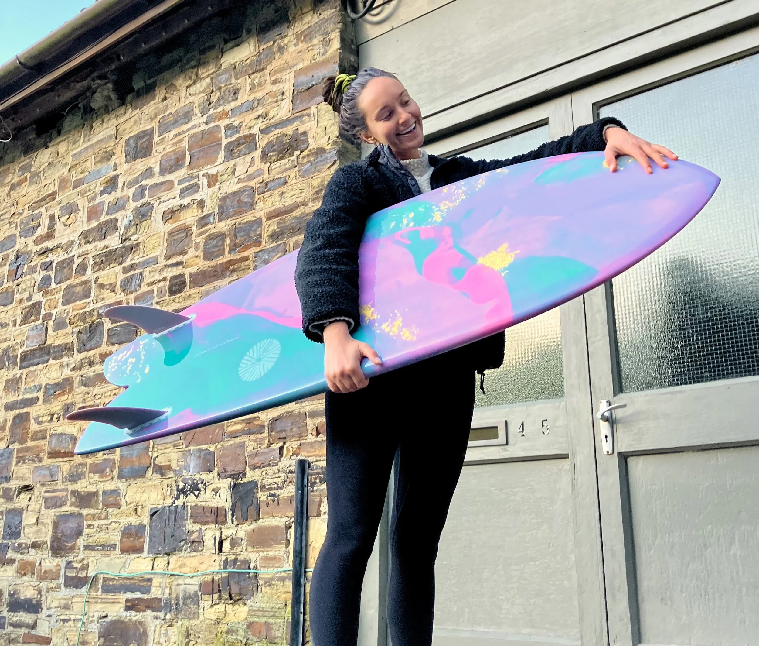 customer with abstract deign custom surfboard gold leaf