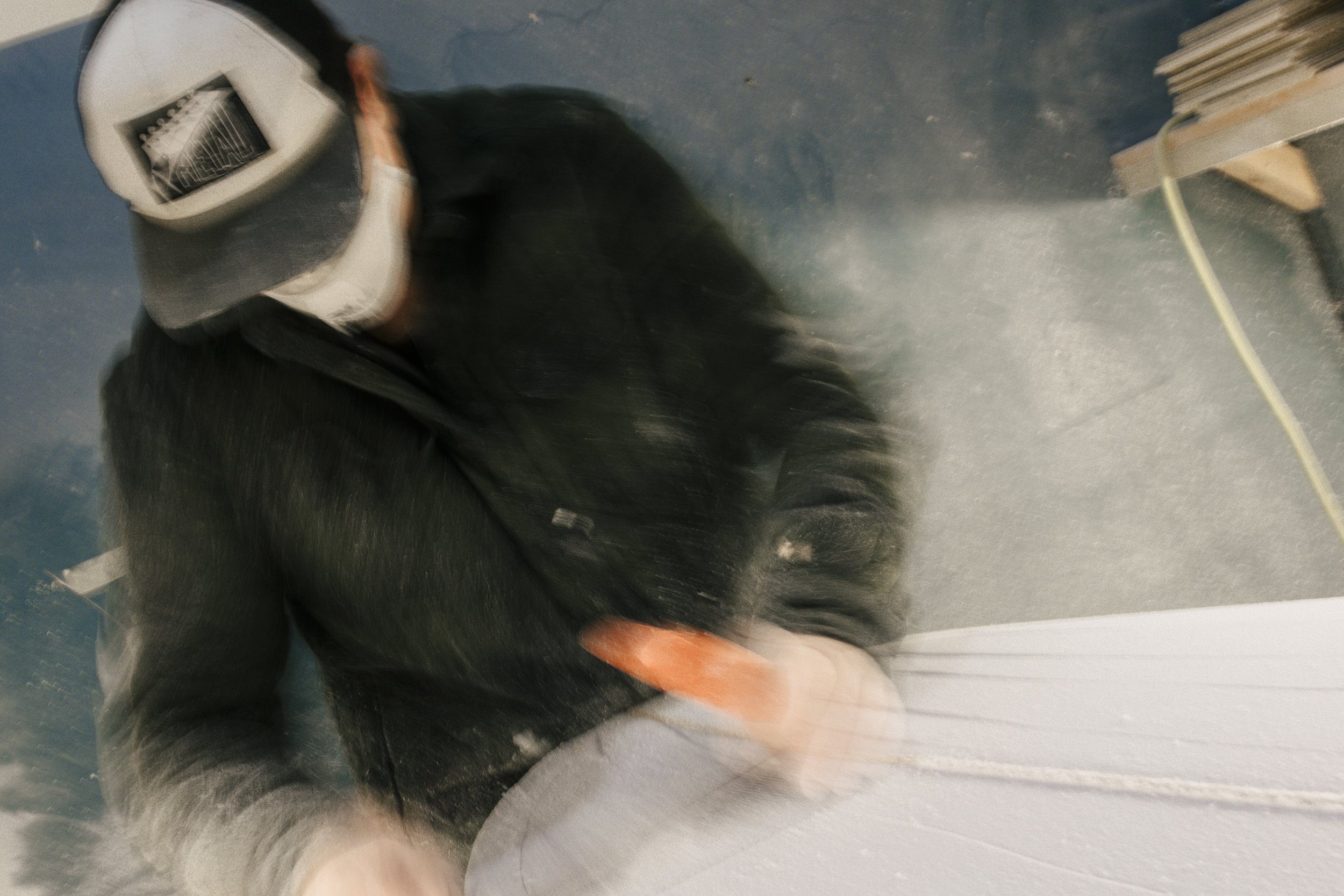 Ellie hand shaping a surfboard