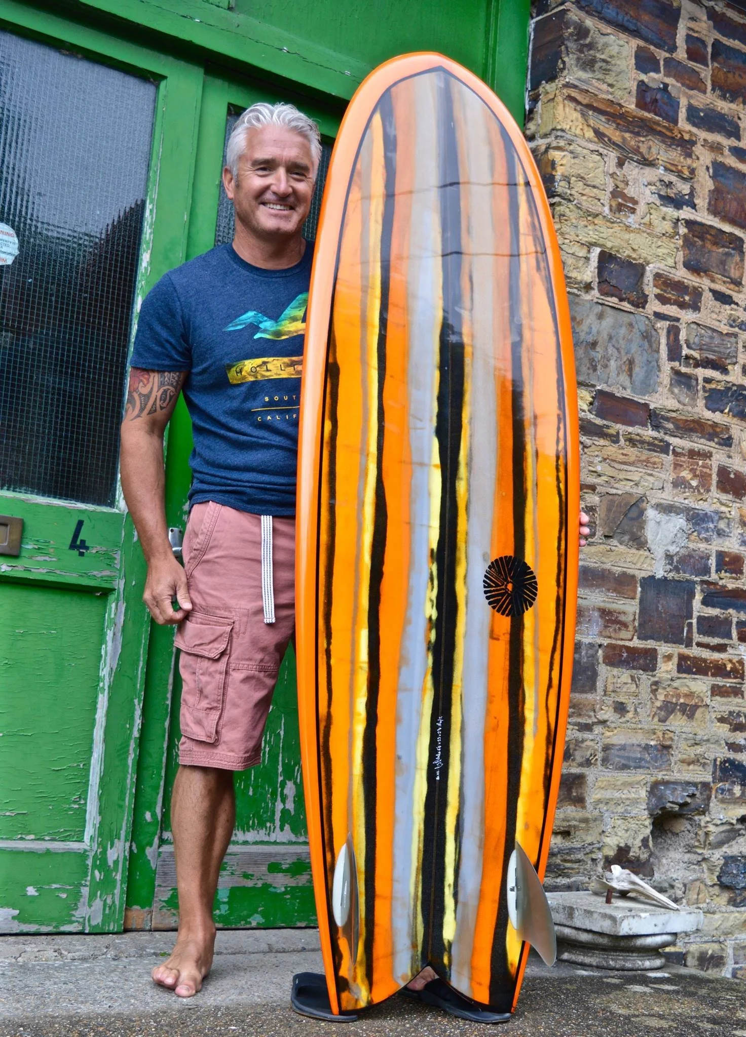 abstract resin tint orange and black mini Simmons surfboard with swallow tail and twin fins