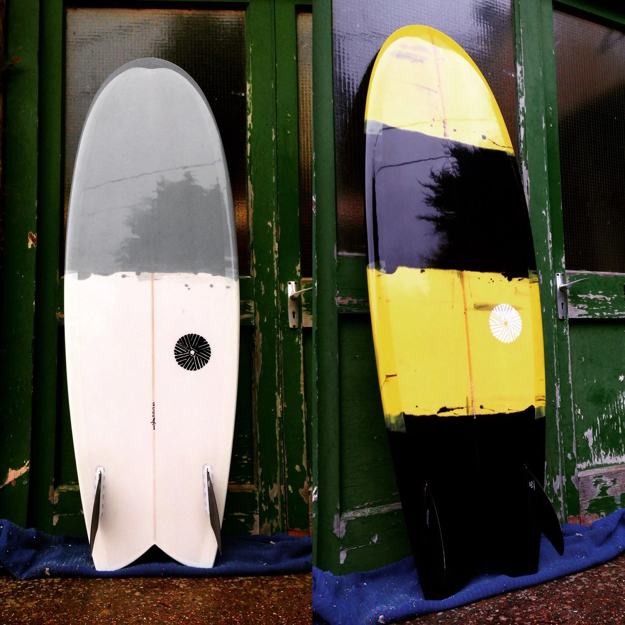 swallow tail surfboard pair in resin tint with twin fins