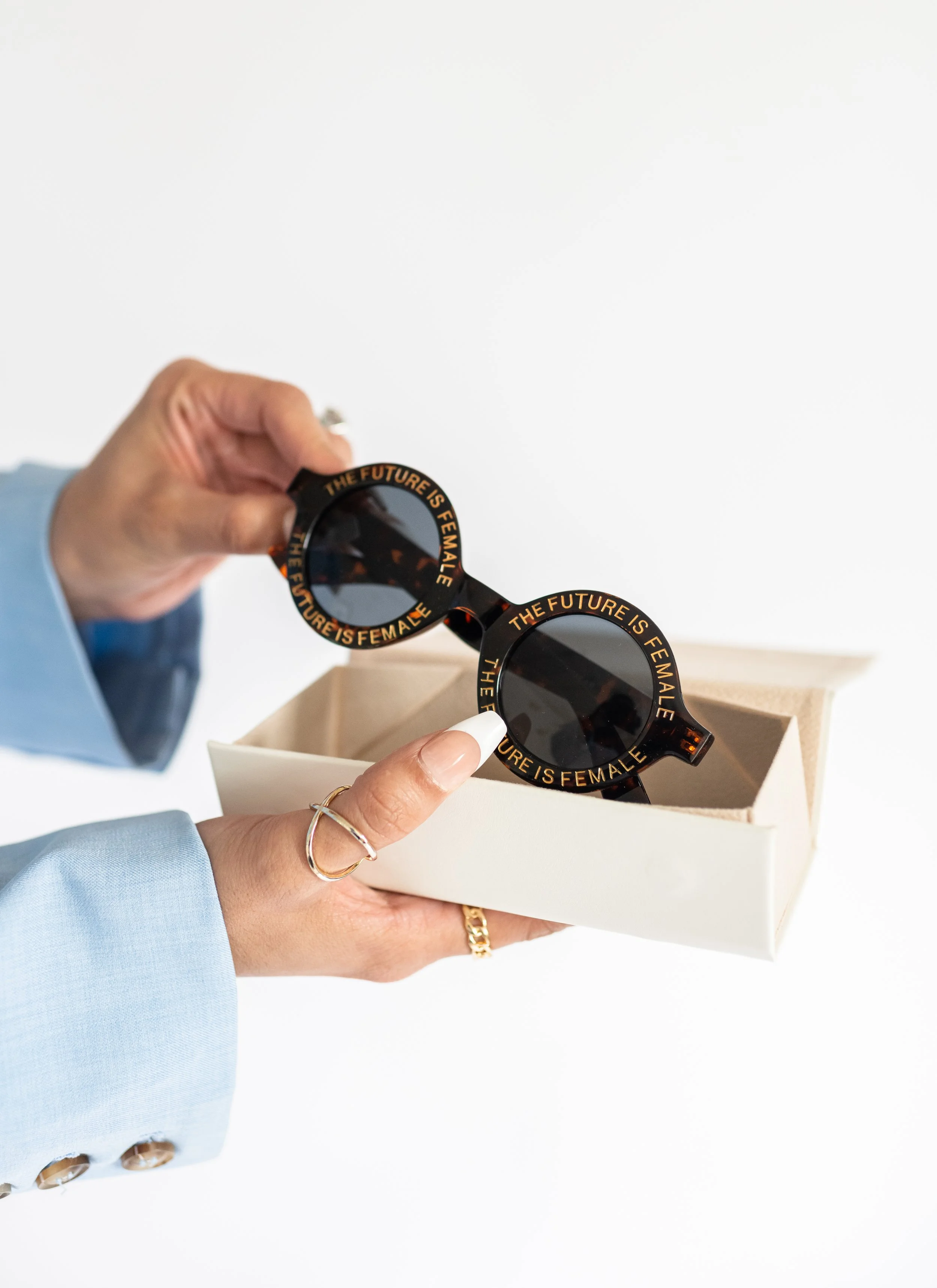 Person holding stylish sunglasses that say \