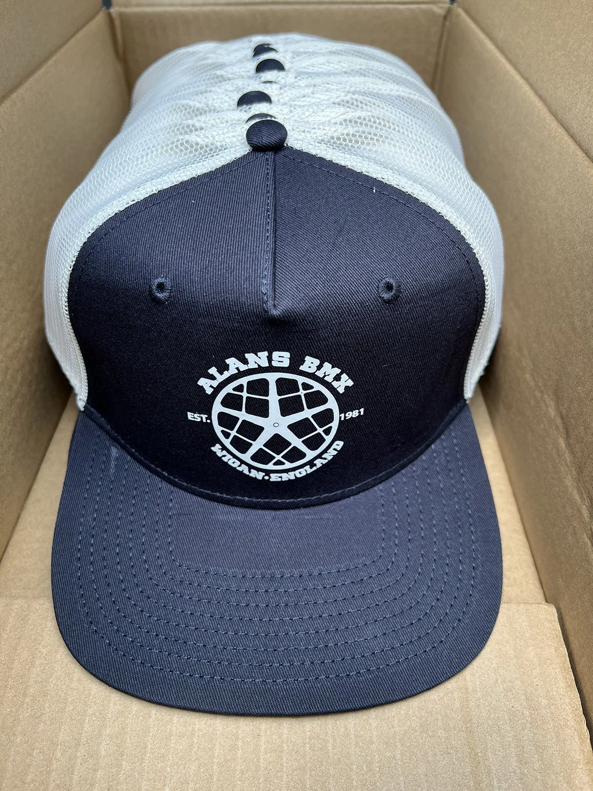 Black and white trucker hat with screenprinted logo for Alans BMX Wigan