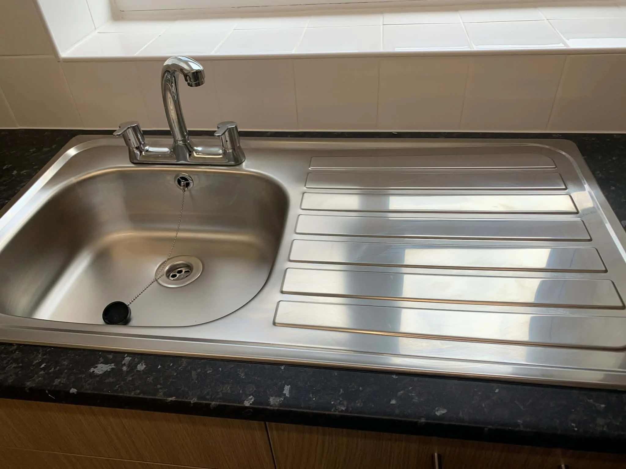 Sink and kitchen surfaces cleaned san sanitised as part of a profesional housekeeping service