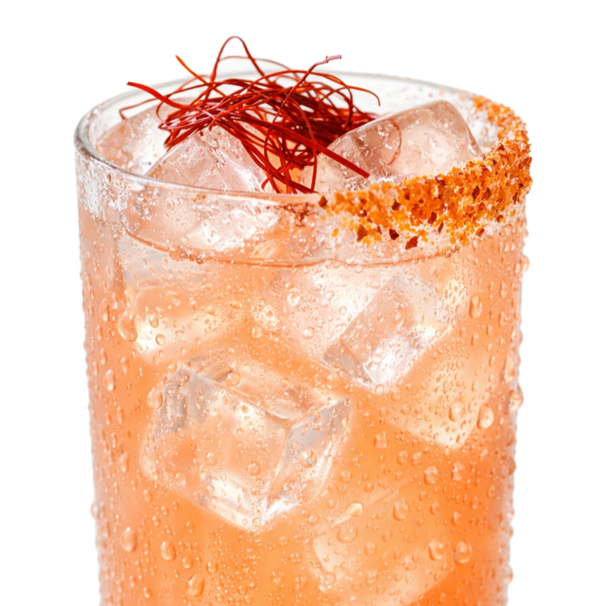 Close-up of a glass of iced cocktail garnished with chili powder and red chili threads