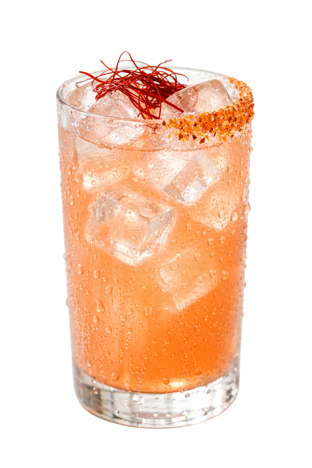 A tall glass of a pink cocktail with ice, garnished with red threads and a salted rim, condensation on the outside.