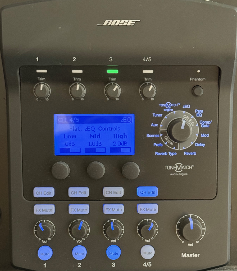 A Bose ToneMatch audio engine with various control knobs and a blue display screen showing audio settings for channel 4/5, including equalizer controls, volume knobs, and mute buttons.