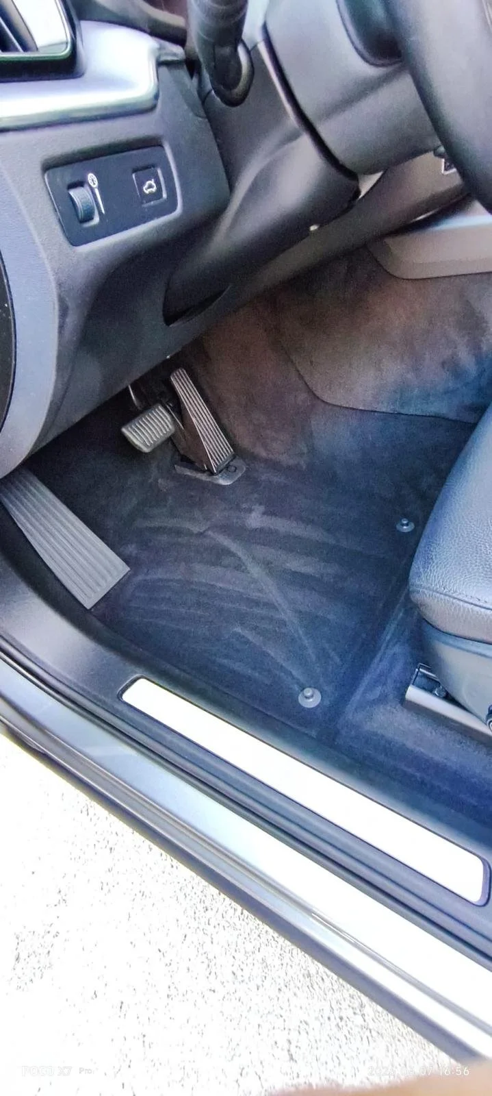 Interior of a car showing the driver’s side footwell, accelerator, brake pedals, and part of the dashboard.
