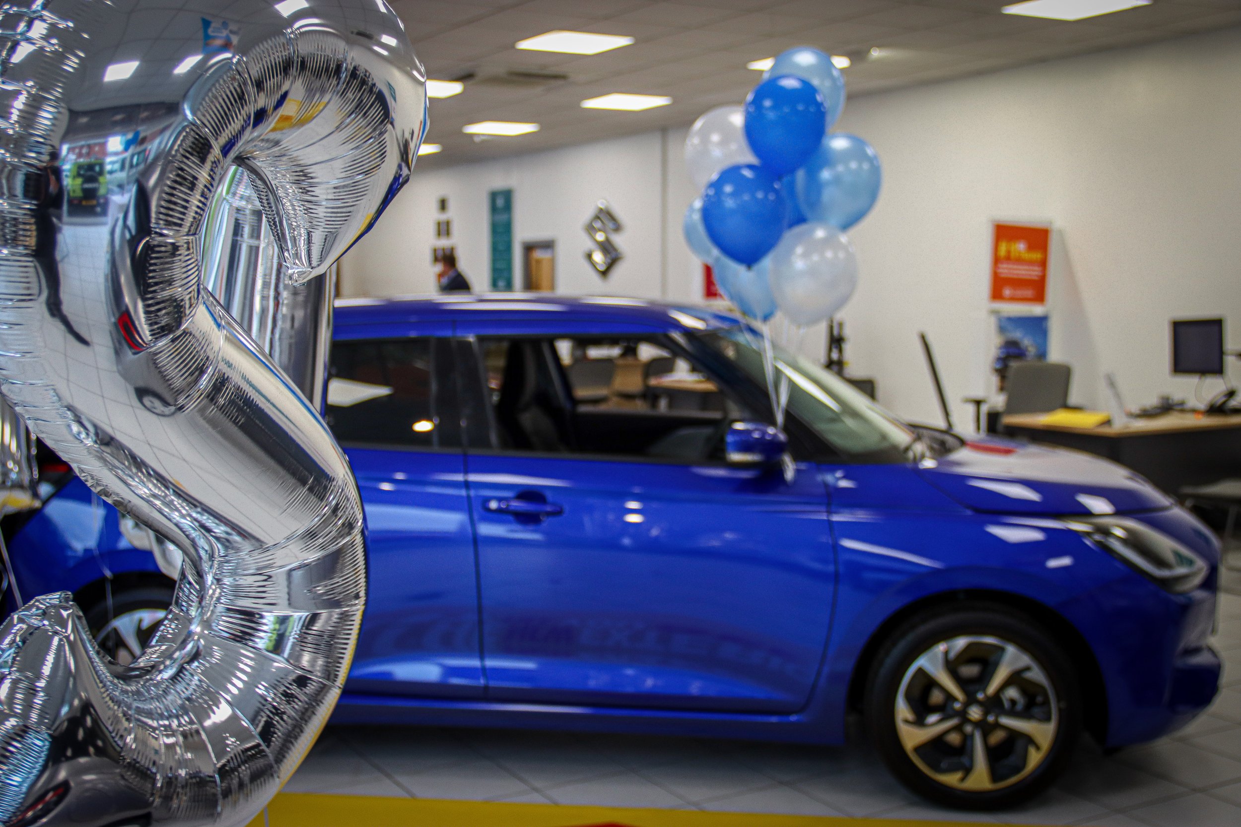 Luscombe's Suzuki Swift Launch Event, with a silver S balloon in the foreground.