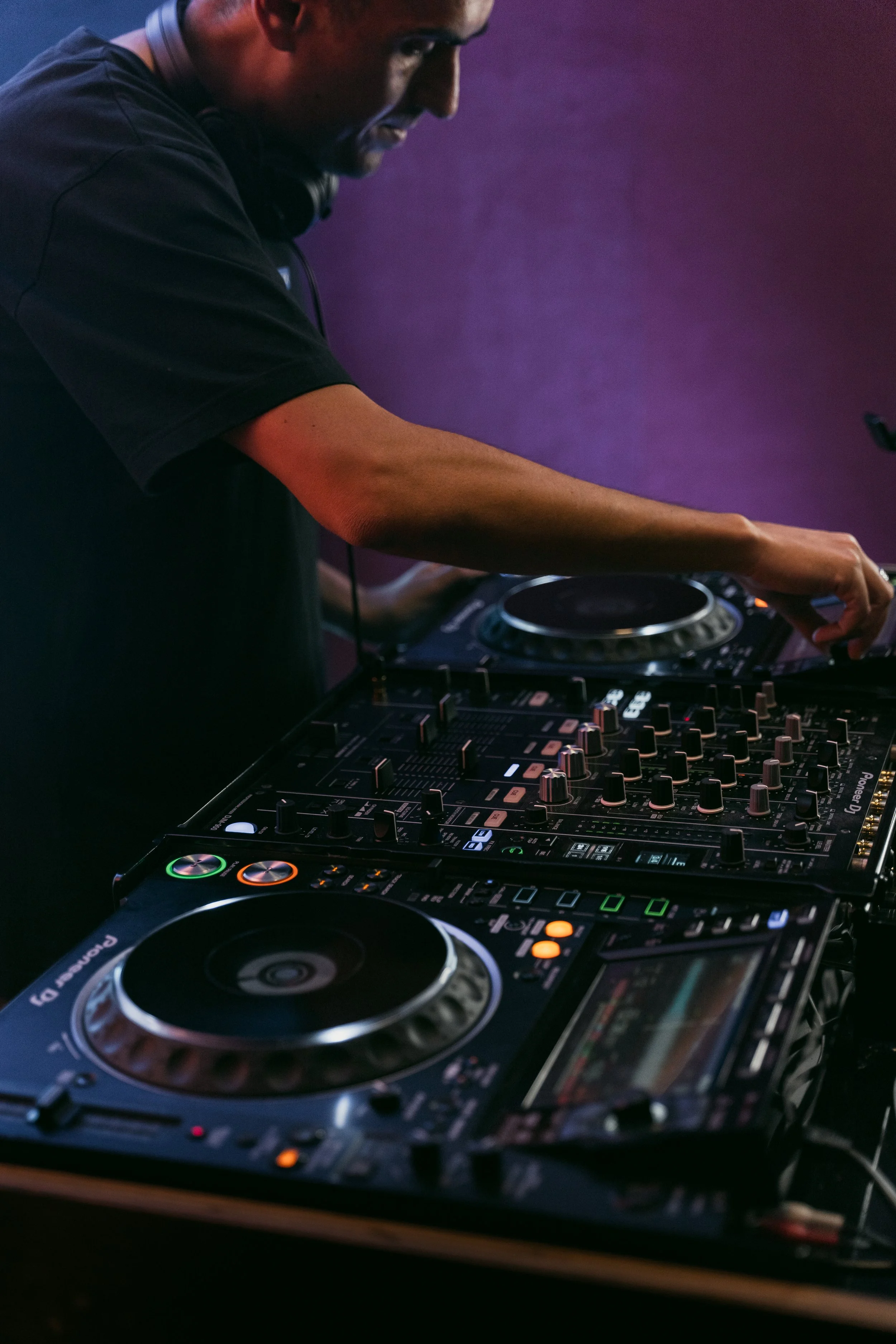 DJ TROV performing live on DJ decks at an event in Perth, Western Australia