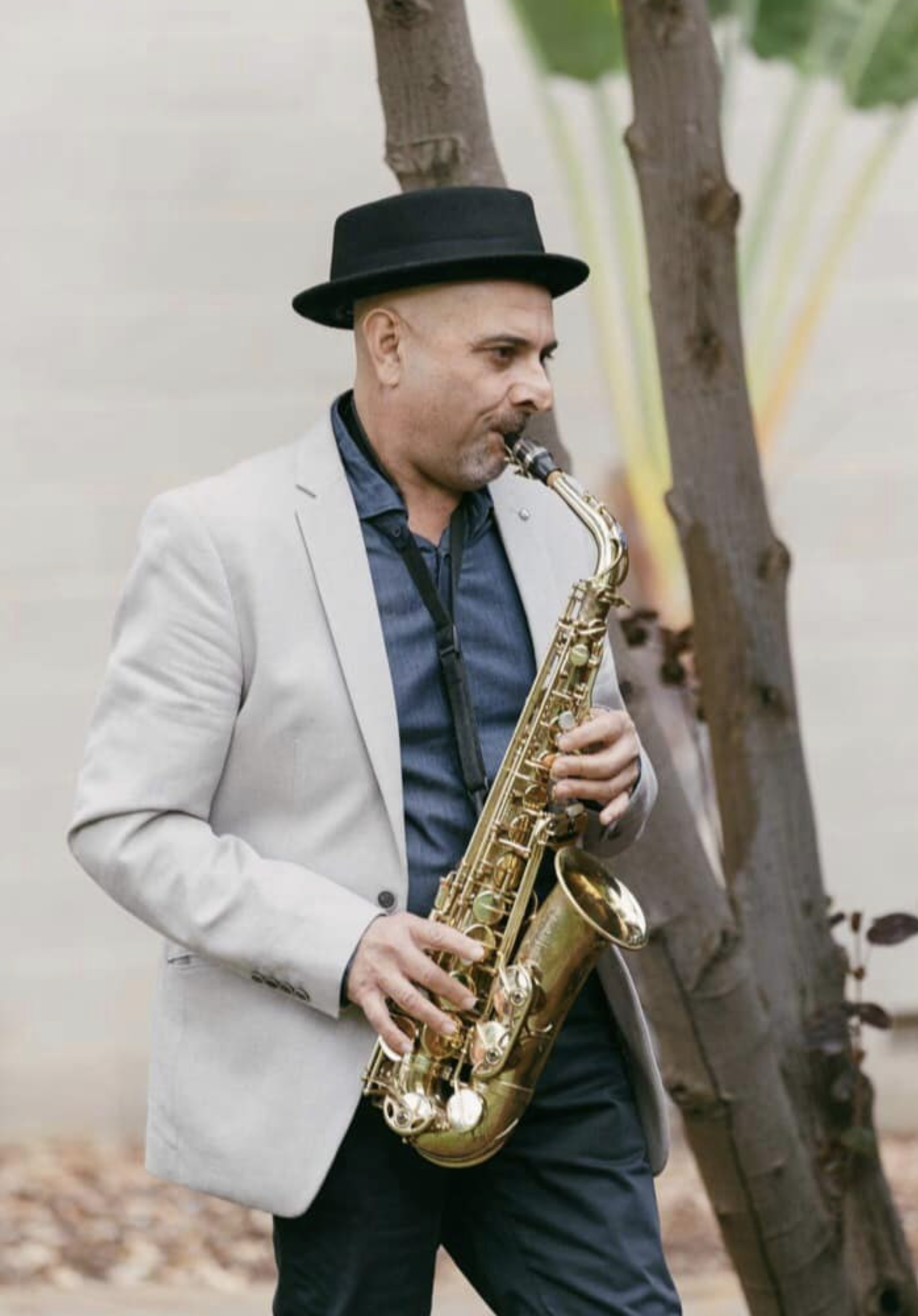 DJ TROV performing with a live saxophonist at a wedding reception in Perth