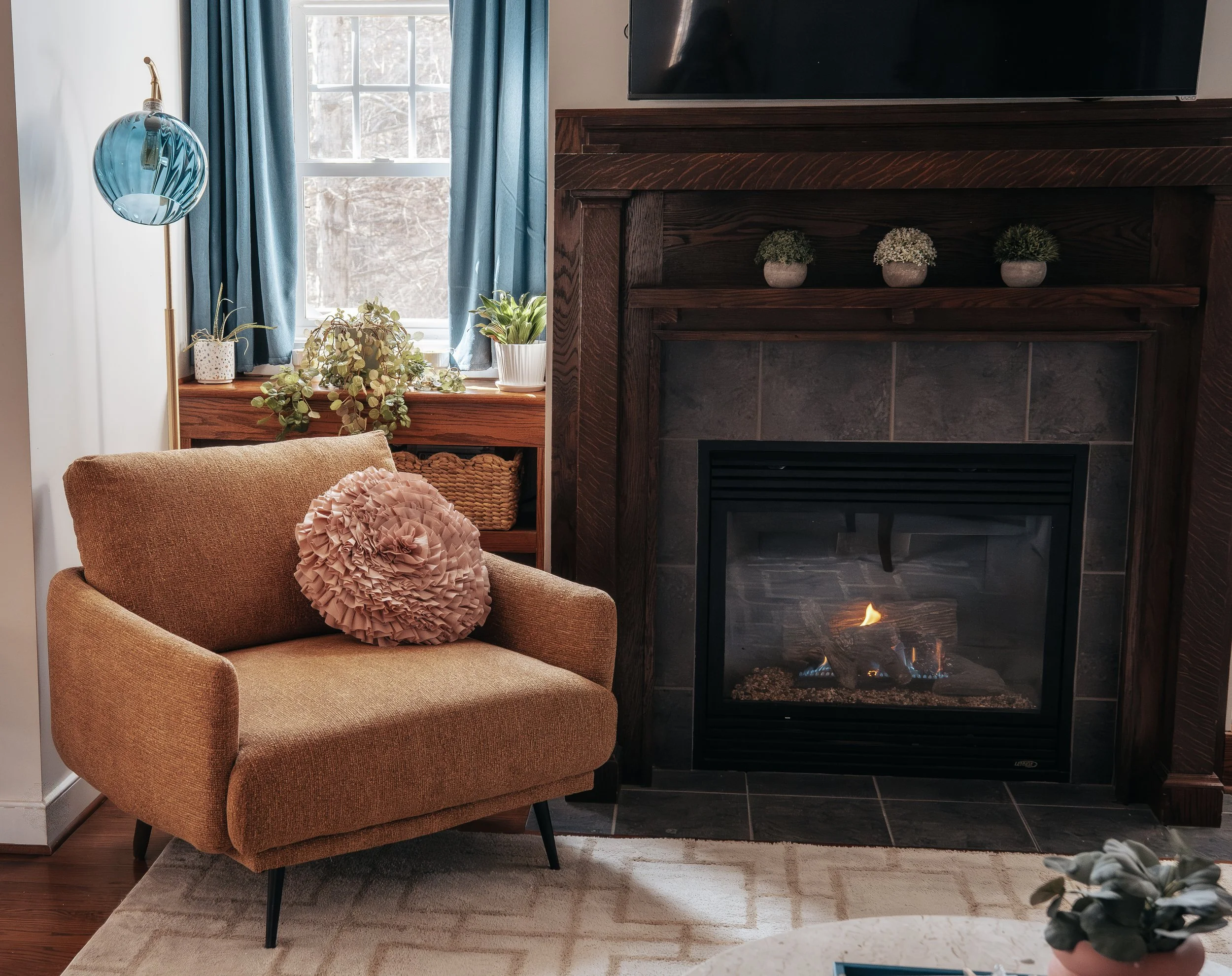 FIRESIDE READING NOOK - 

The art of pause. This corner utilizes warm ochre and natural wood to anchor the senses, creating a grounded sanctuary for quiet reflection by the fire.