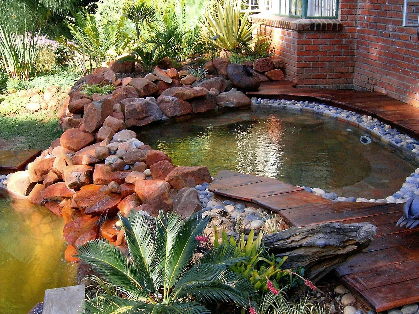 Mixed pebbles lining around the wood with some crypt rock 
