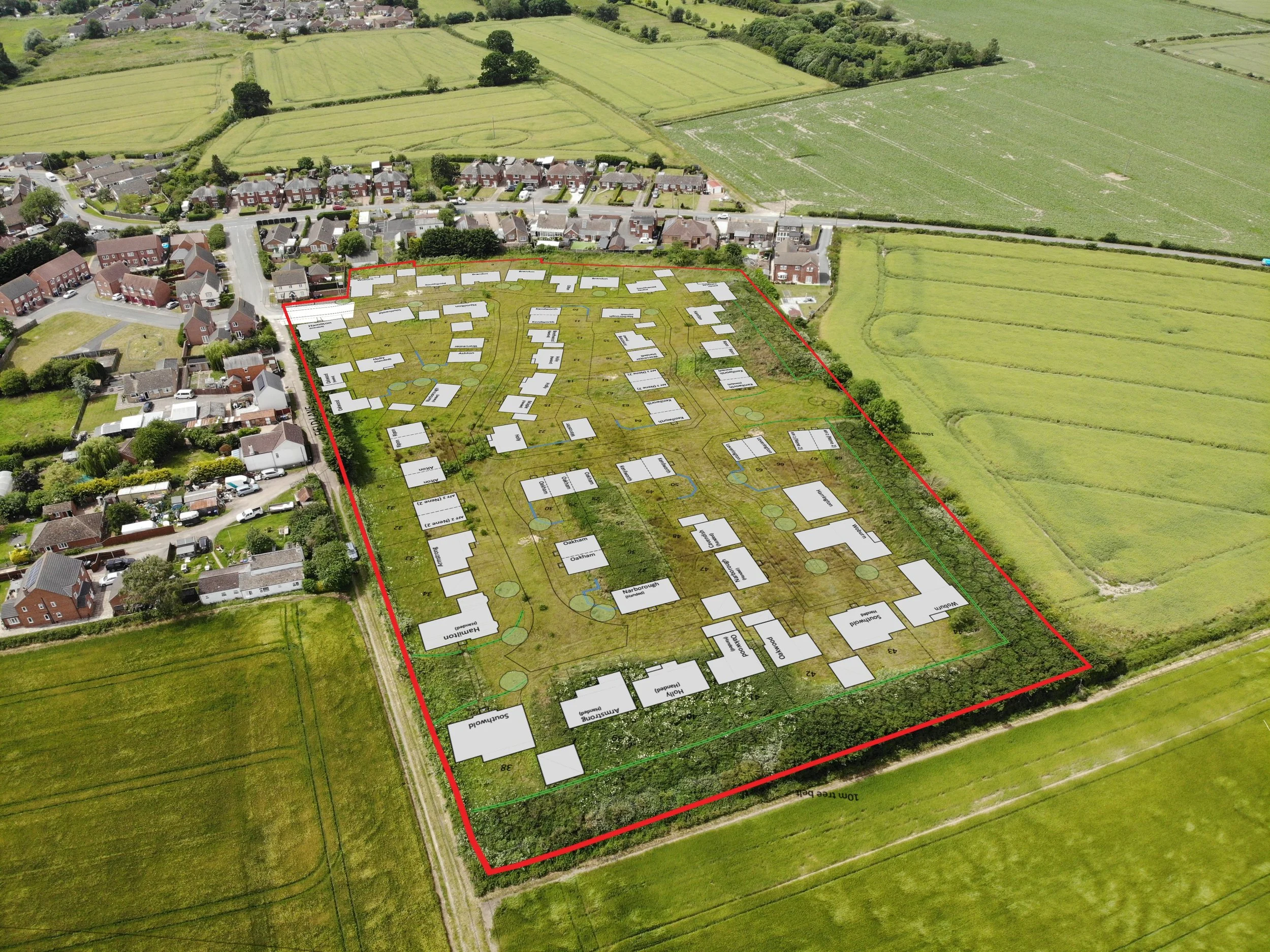 Aerial view of a new housing development plan with labeled houses, roads, and green spaces, outlined by a red perimeter and situated next to existing homes and open farmland.