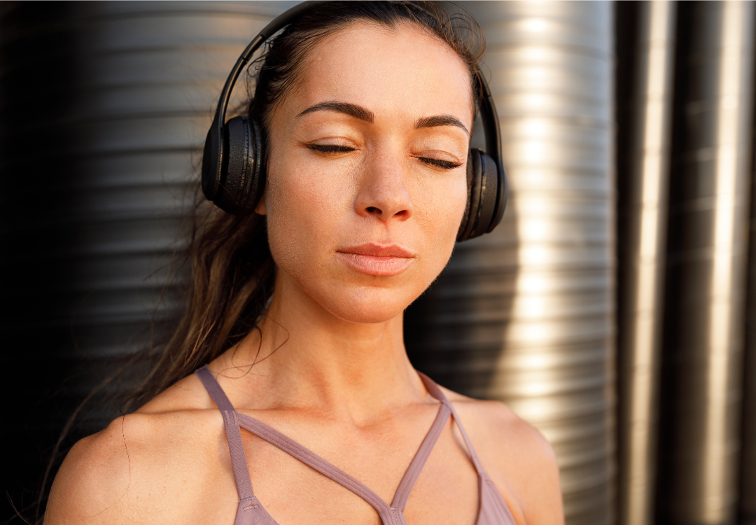 Woman listening to a personalised hypnosis recording by Jess Pittam — RTT therapist and clinical hypnotherapist Dubai
