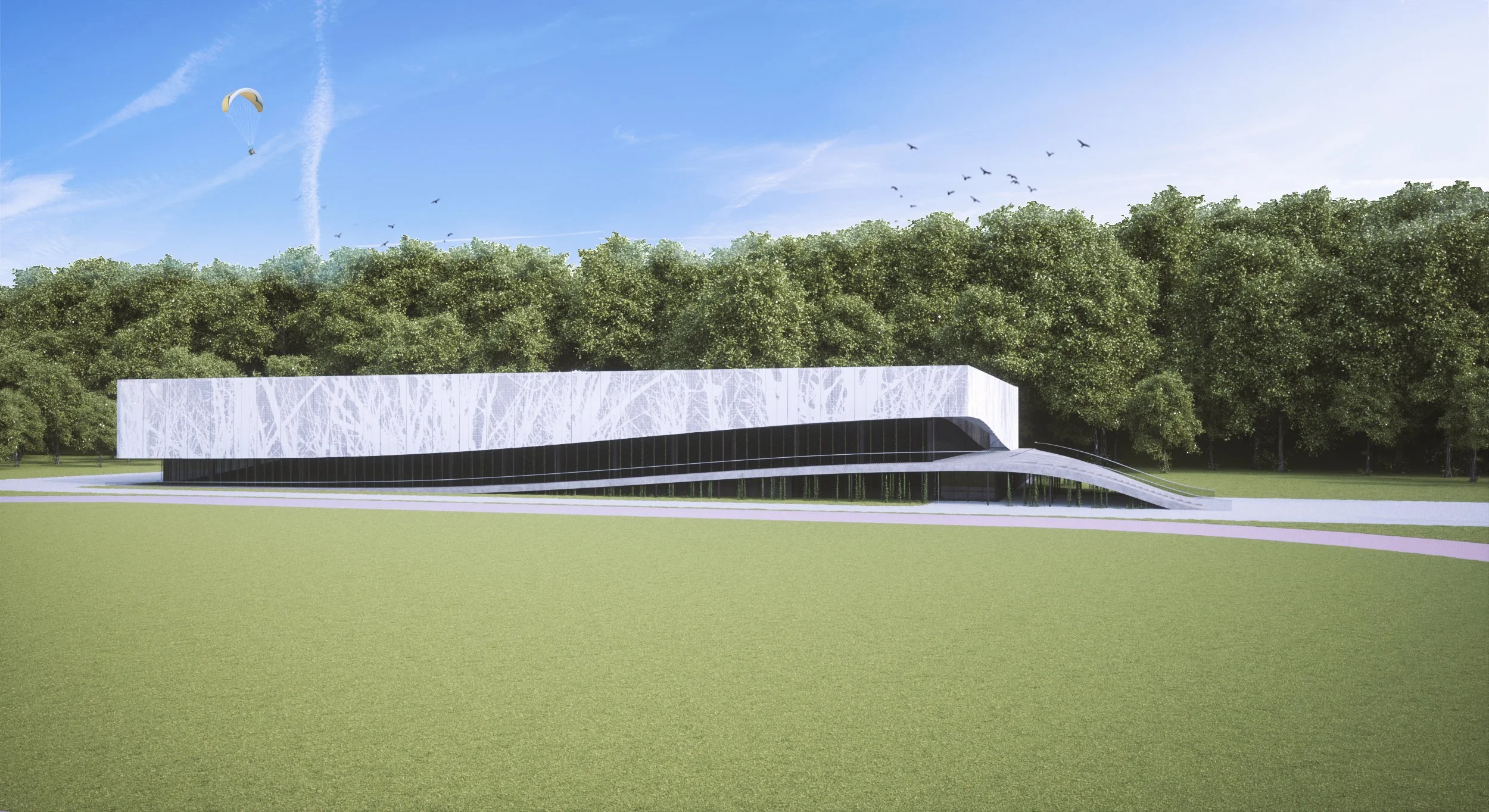 A modern architectural building with a curved roof and a glass facade, situated on a grassy field with trees in the background under a bright blue sky with clouds and a paraglider flying.