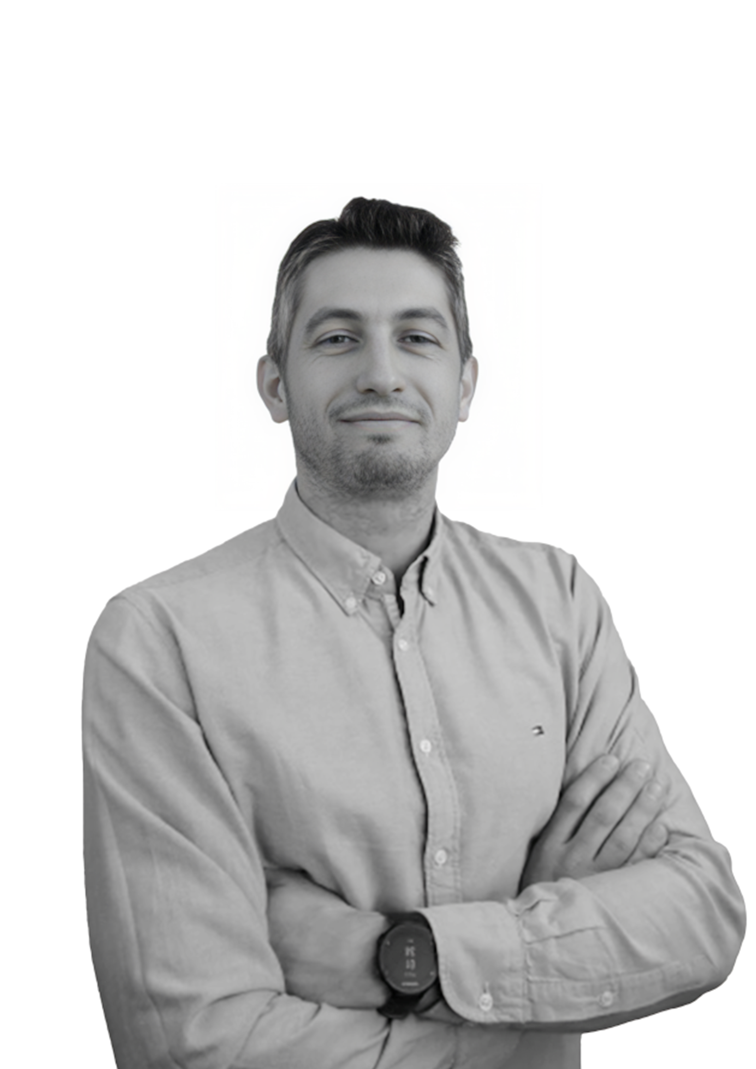 Black and white portrait of a man with arms crossed, wearing a button-up shirt and a smartwatch.