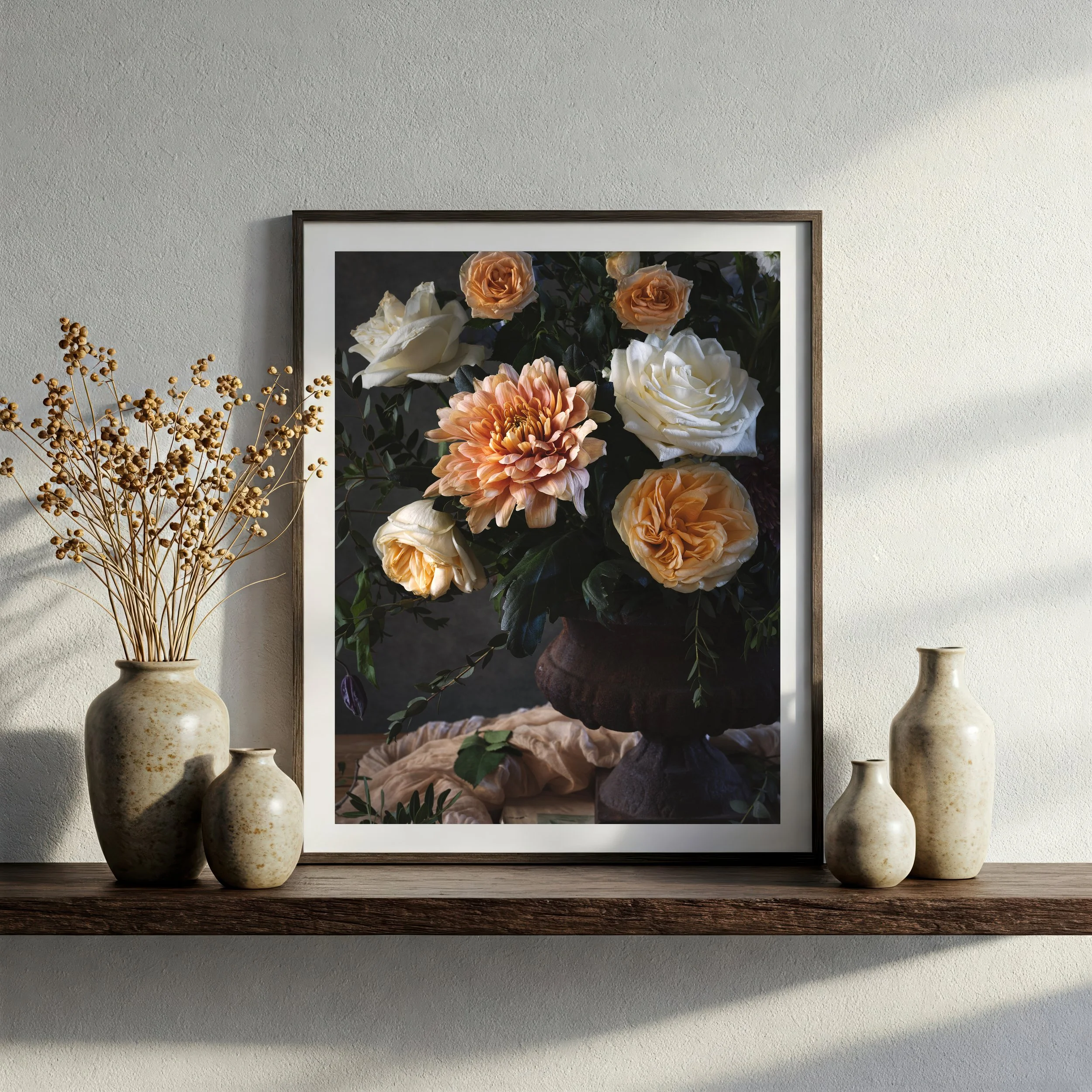 A large white dahlia flower with layered petals, surrounded by green leaves and smaller flowers, against a dark background.