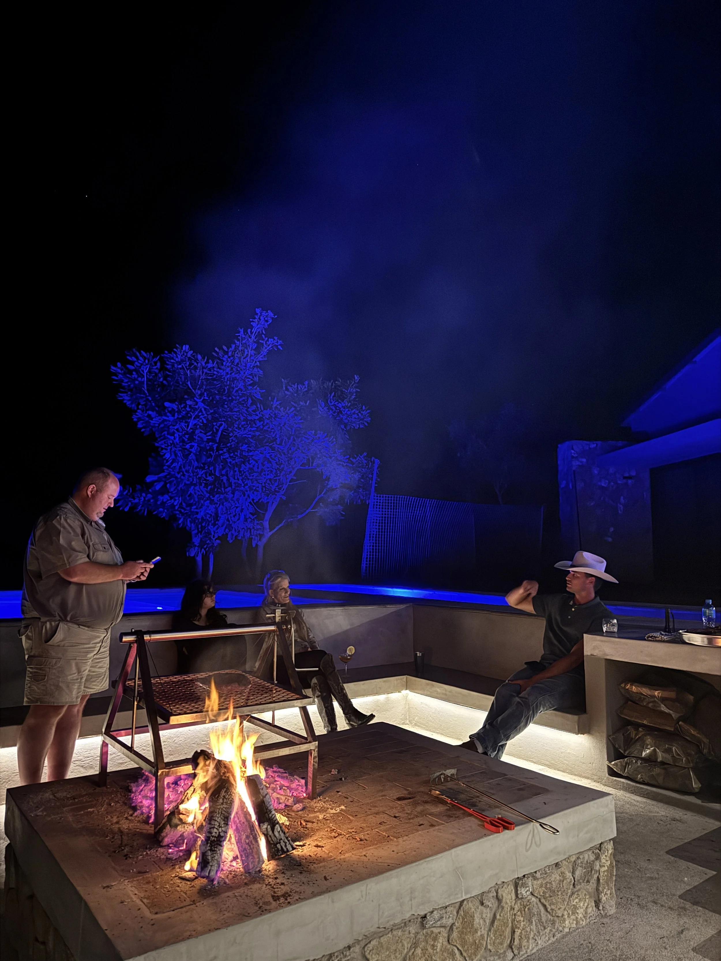 Clients sharing stories by the fire.