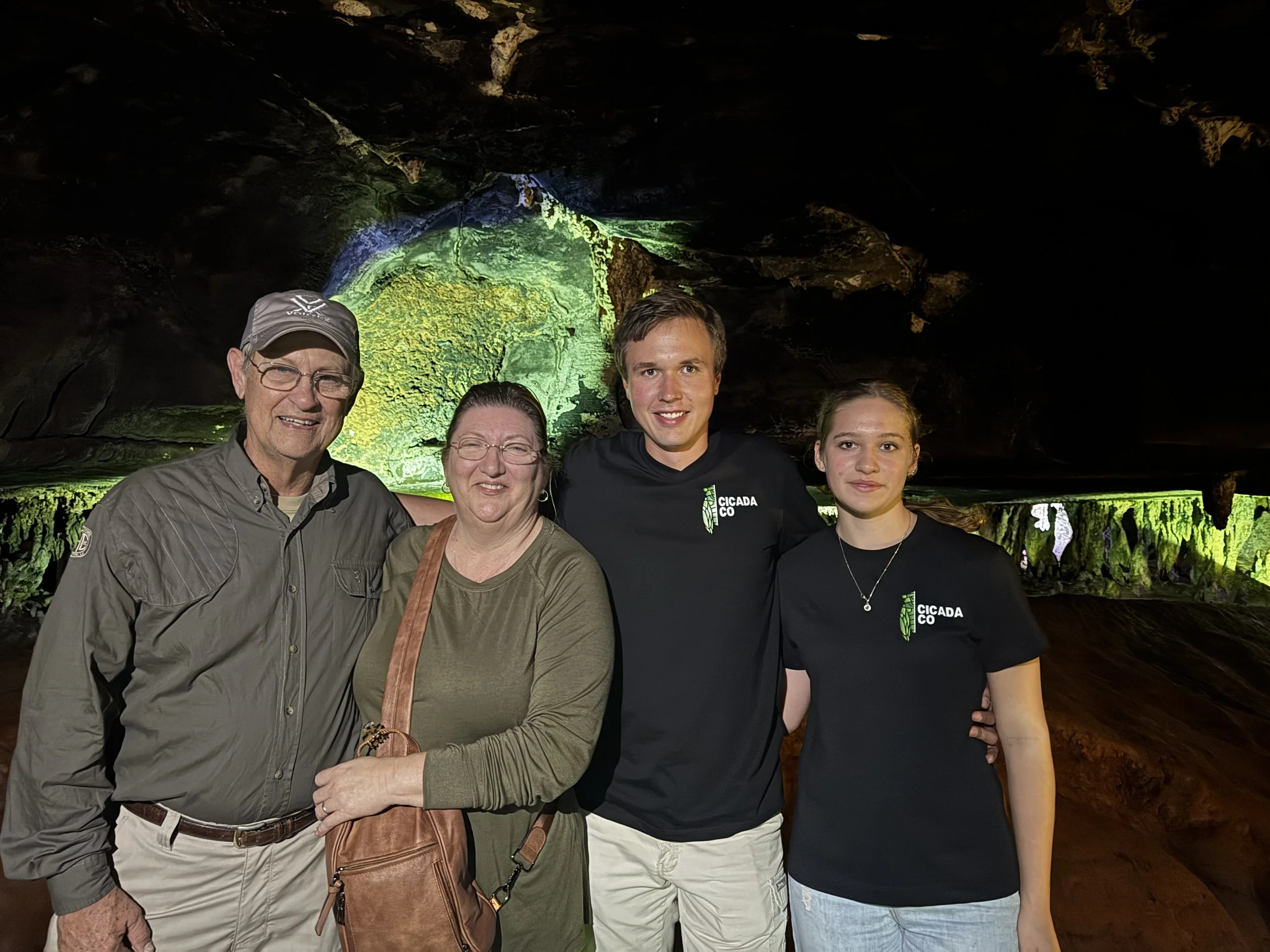 CicadaCo owners Adriaan and Kaylin standing with guests while exploring a cave during a guided safari adventure in South Africa.