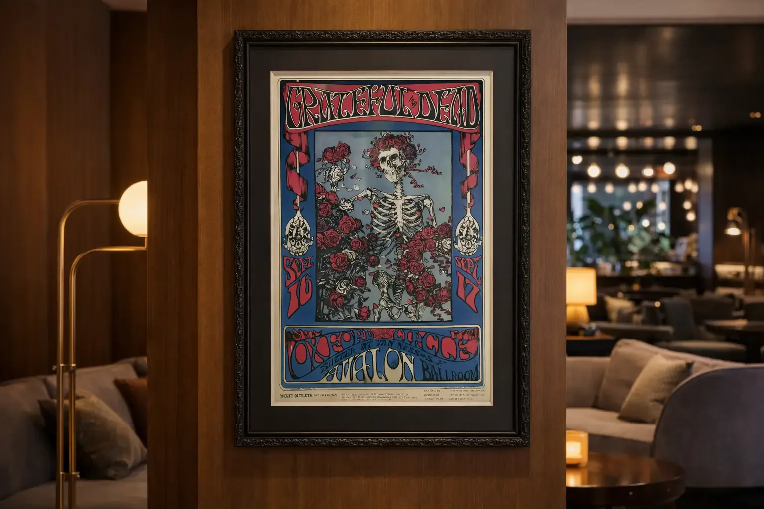 A framed poster for the band Grateful Dead featuring a skeleton surrounded by roses and ornate decorative elements, with text promoting a concert in Minneapolis.