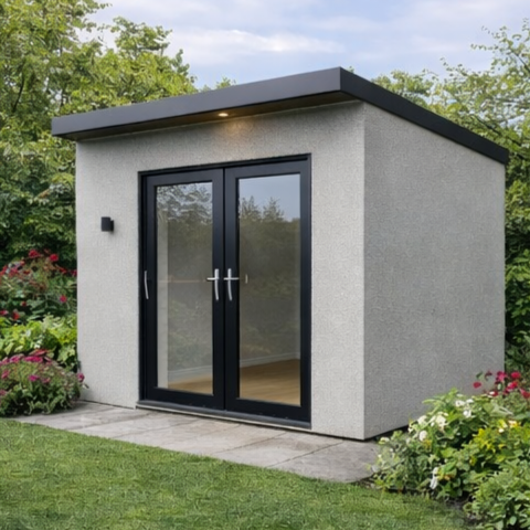 A completed Steel Frame Garden Room with glass double doors, surrounded by green grass and colorful flowers, with trees in the background.