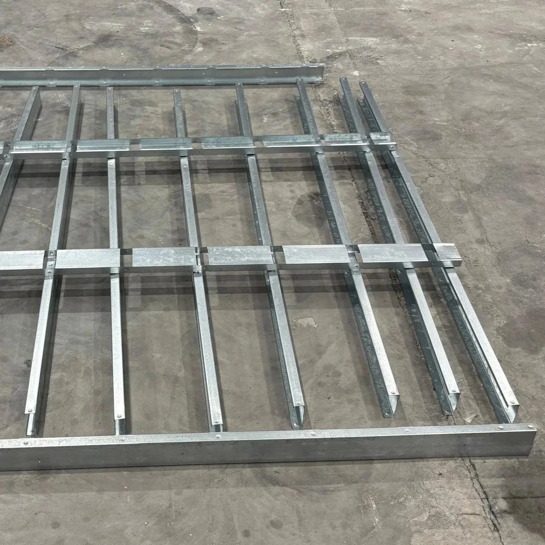 steel frame base laid out on the floor ready for assembly