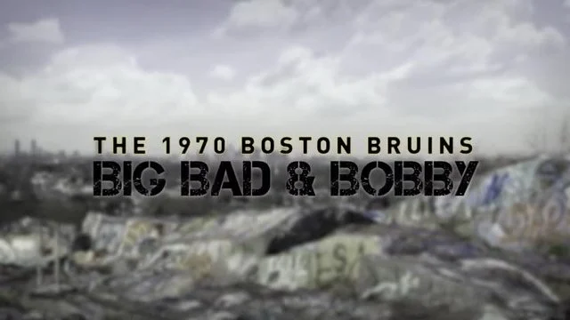 Title card reading "The 1970 Boston Bruins Big Bad & Bobby" over a background of a graffiti-covered rooftop or ledge under a cloudy sky.