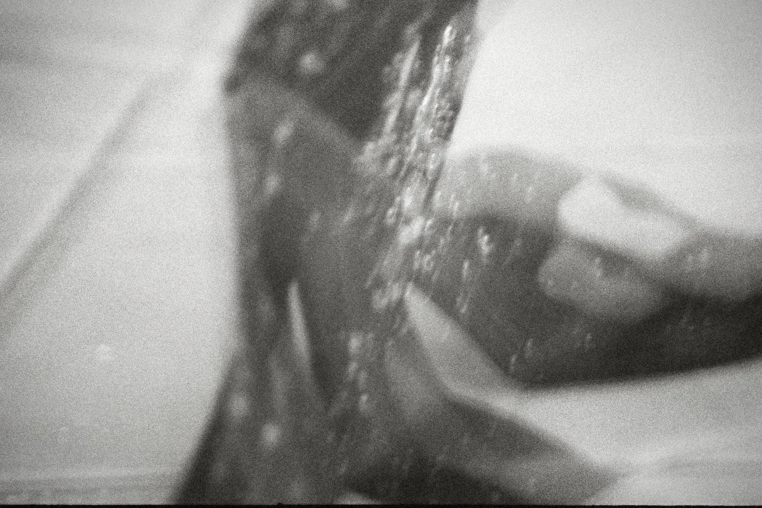 Black and white ananlogue photo, blurred light and shadow effects, creating a surreal atmosphere.