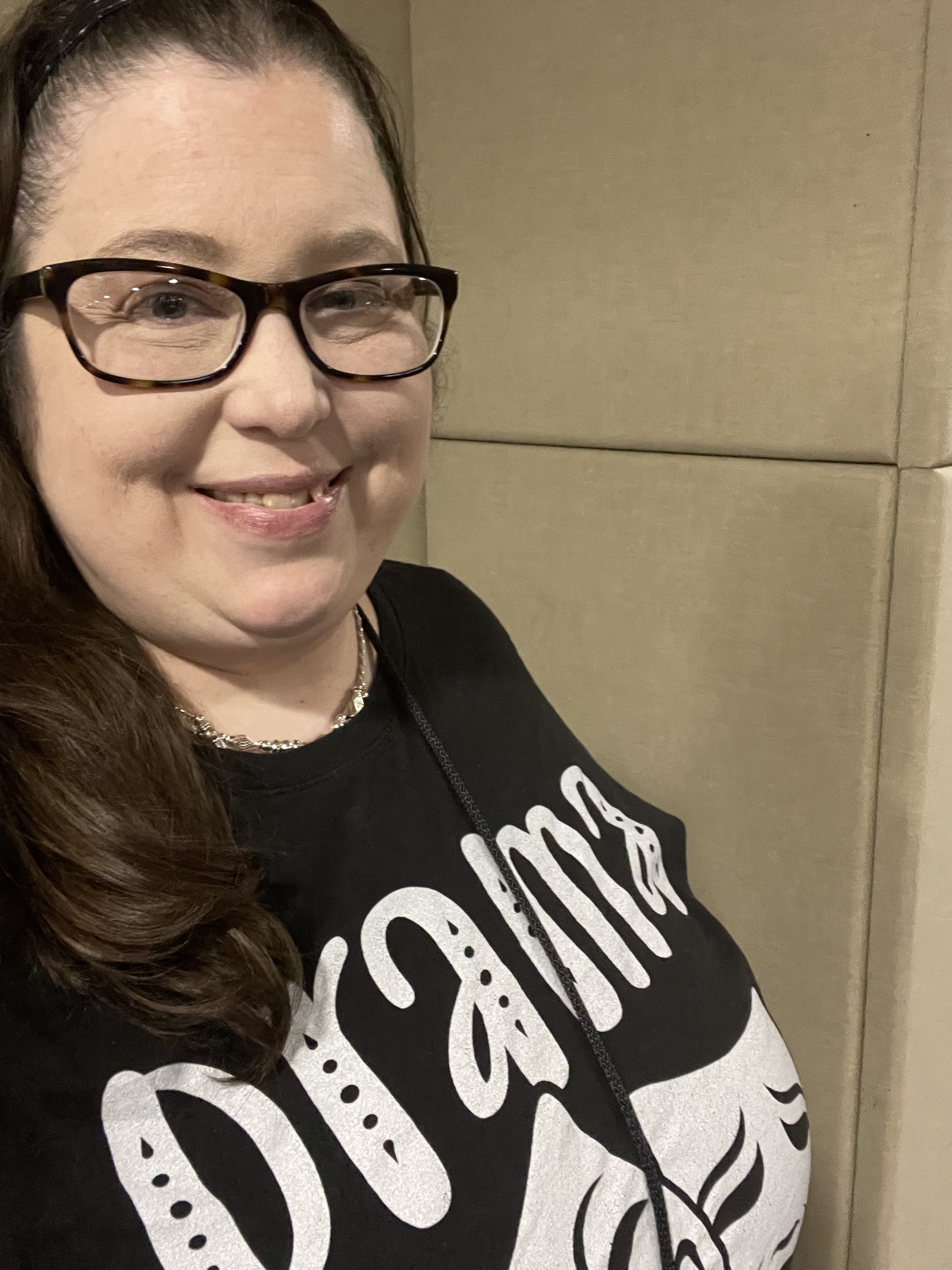 A woman with glasses, long brown hair, and a black t-shirt labeled "Diabetes" smiling.