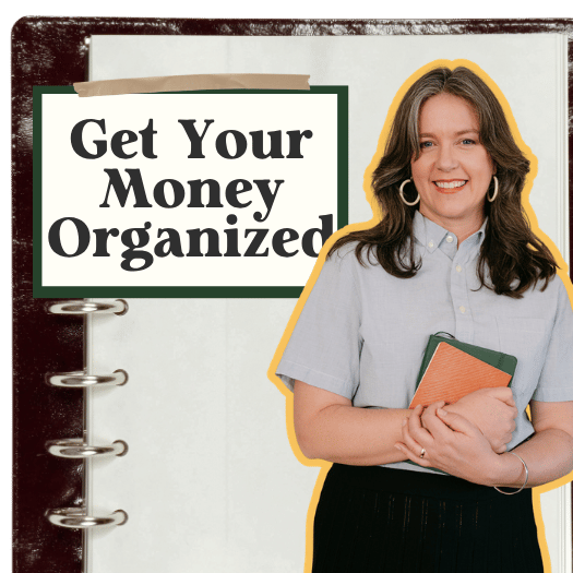 A woman holding notebooks standing in front of a sign that says 'Get Your Money Organized'.