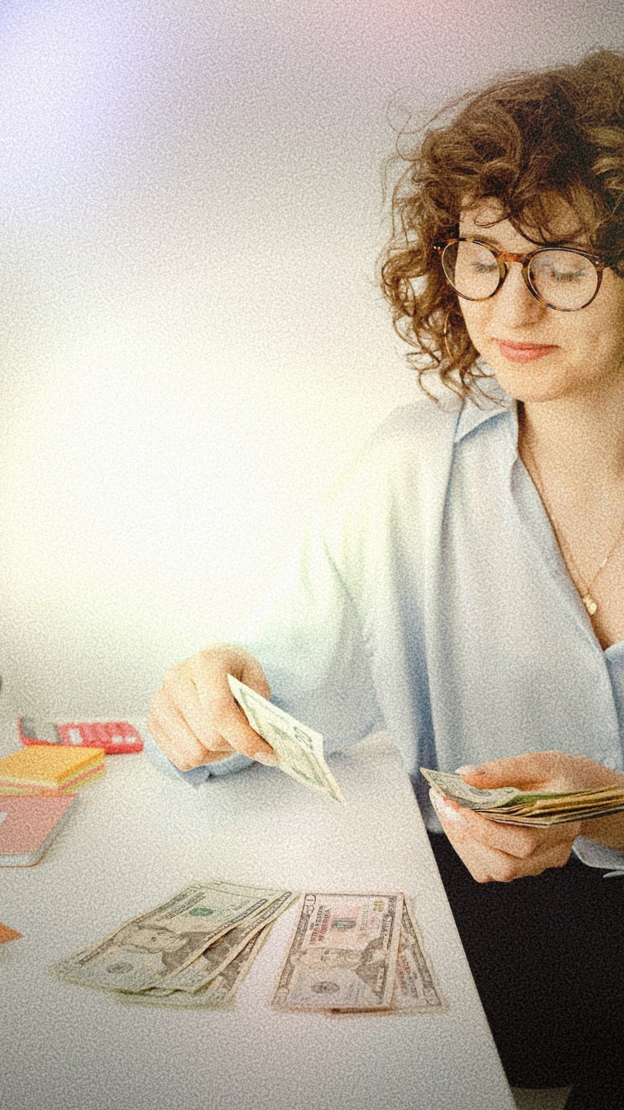 woman counting money, looking content