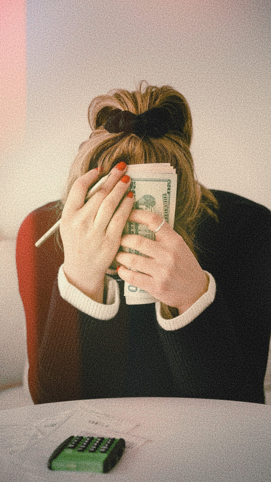 woman trying to sort finances with calculator