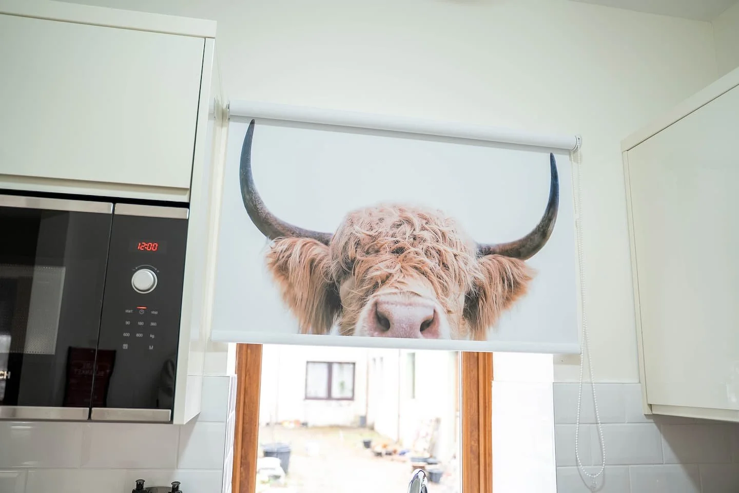 Kitchen with a window cover featuring a high-resolution image of a buffalo's face.