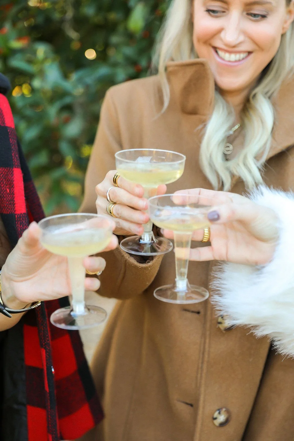 A group of people celebrating with champagne glasses, with a woman smiling in the background