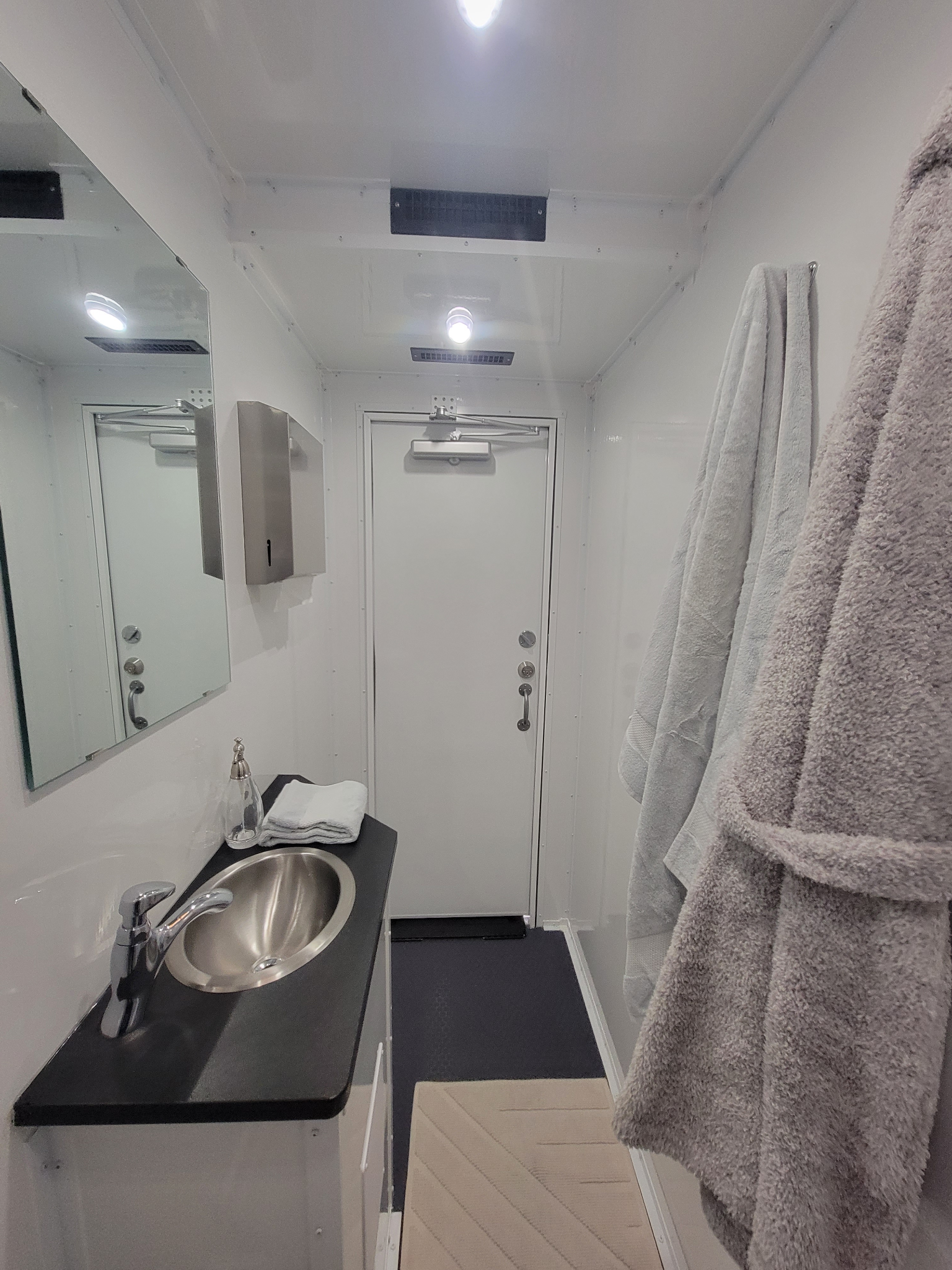 Mobile shower trailer private shower station interior.