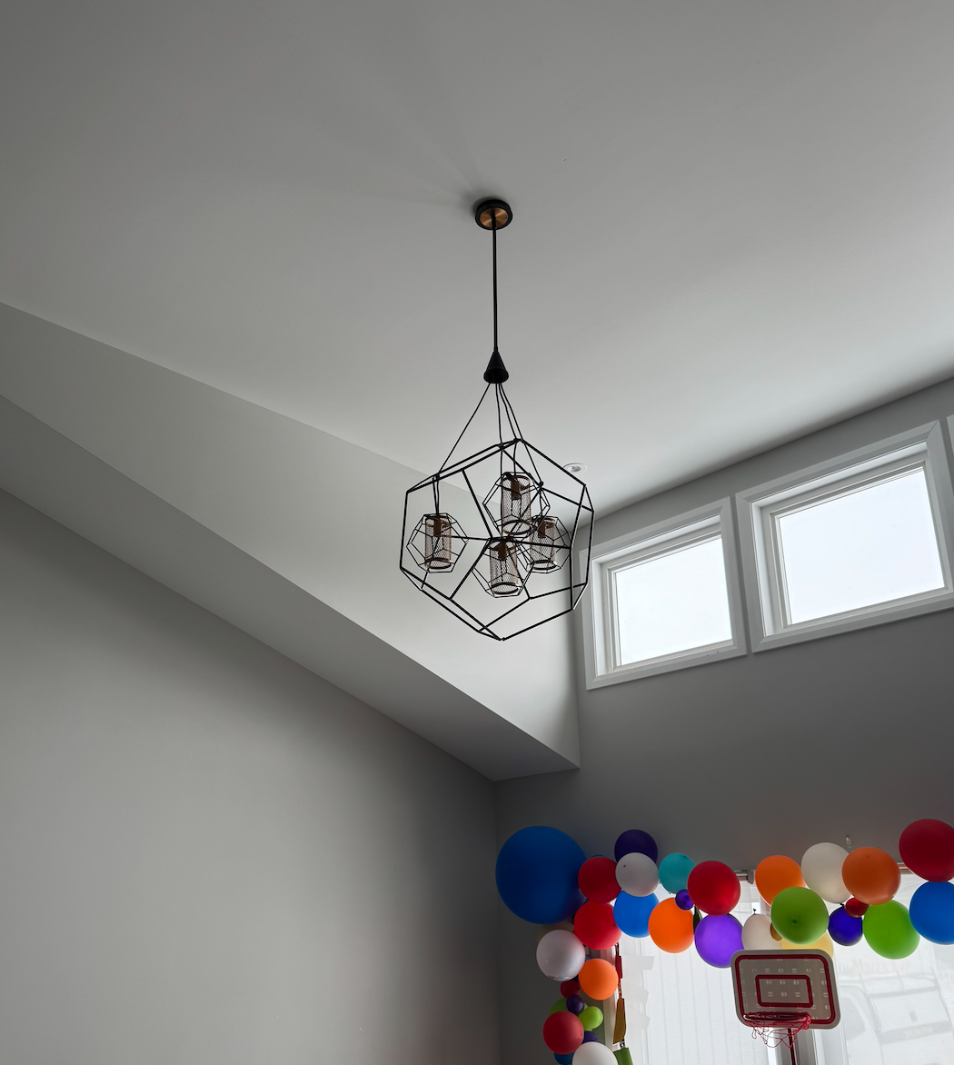 Chandelier on high ceilings with windows 