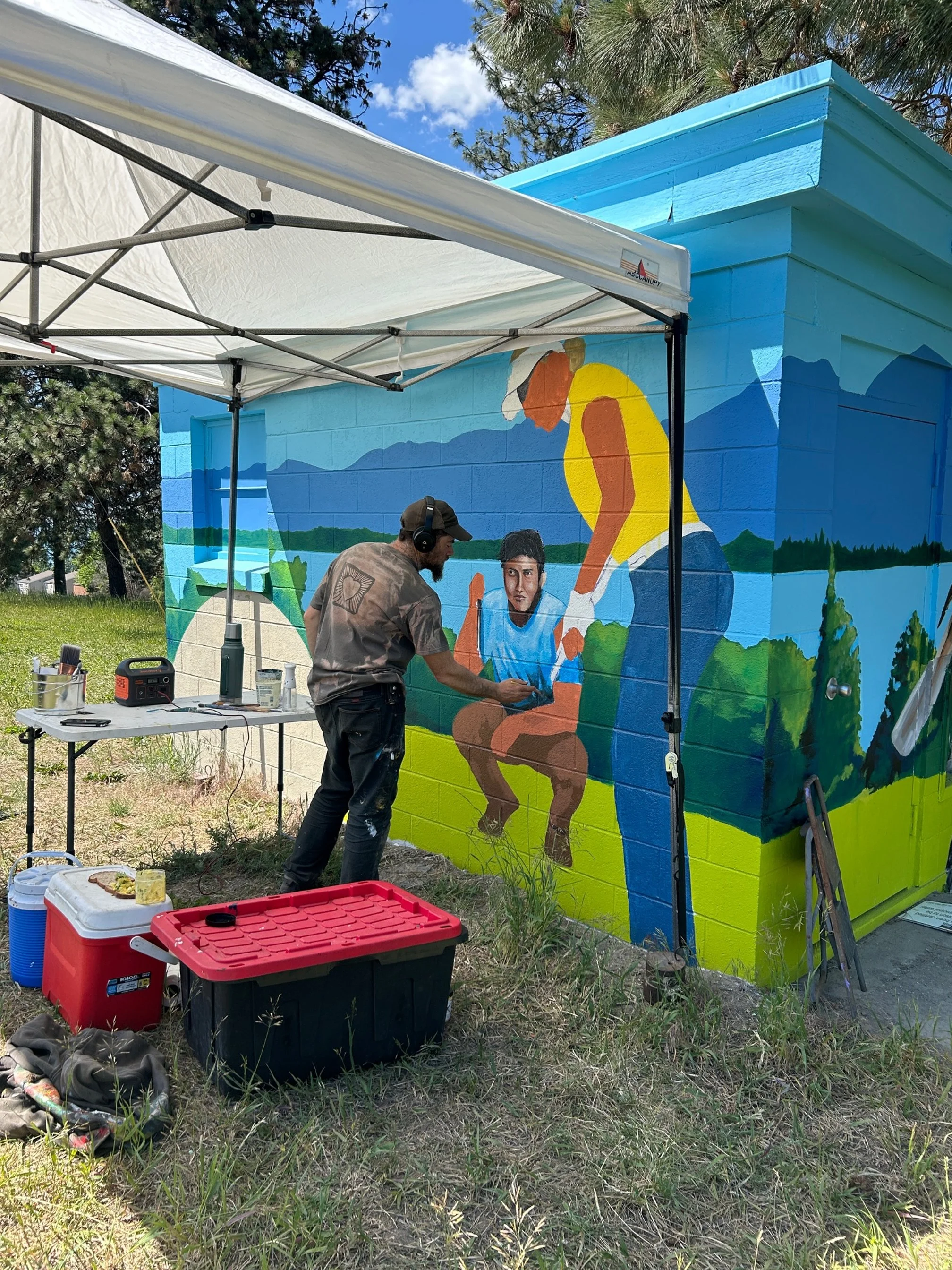 Luke Orsborne painting at the golf course mural
