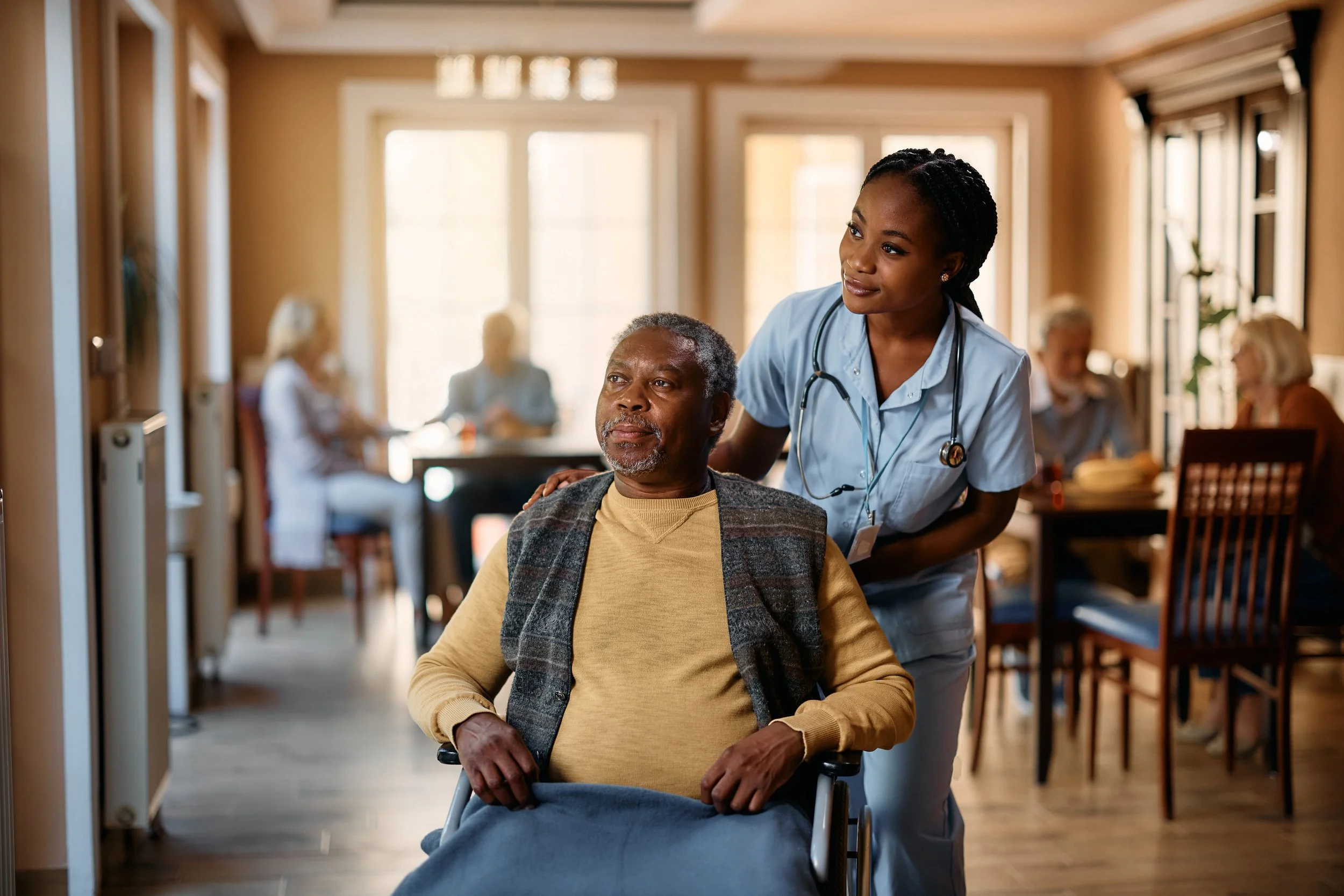 TBI resident receiving daily living support from a caregiver in a Medical Alternatives group home in Southeast Michigan