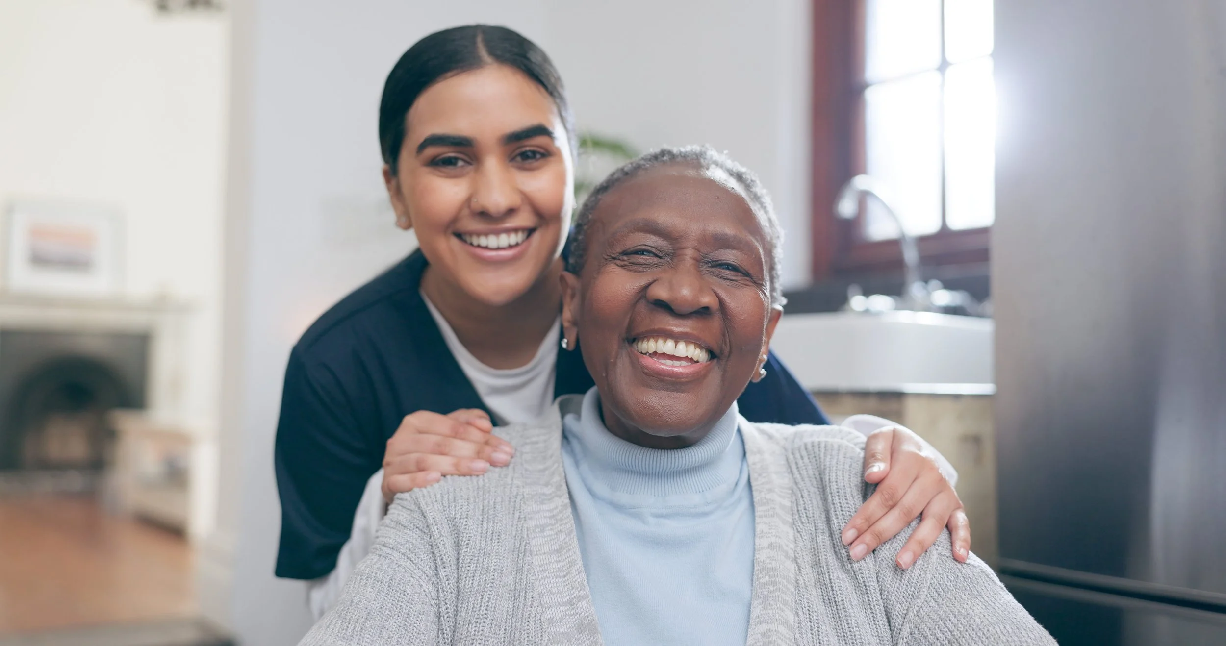 A compassionate Medical Alternatives caregiver smiling with a TBI resident at a group home in Novi, Michigan